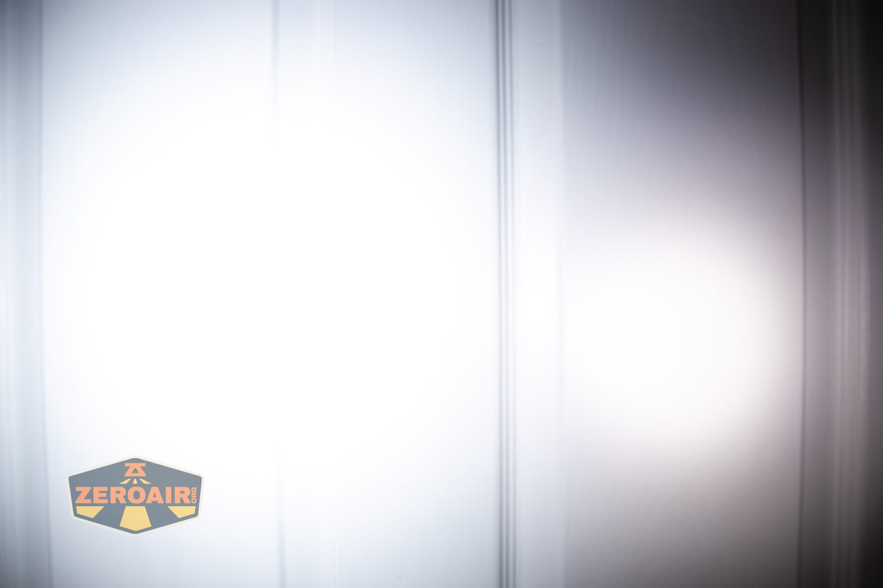 Acebeam UC3A Signal flashlight beamshots on door (at 1') compared to nichia 219b 4500K