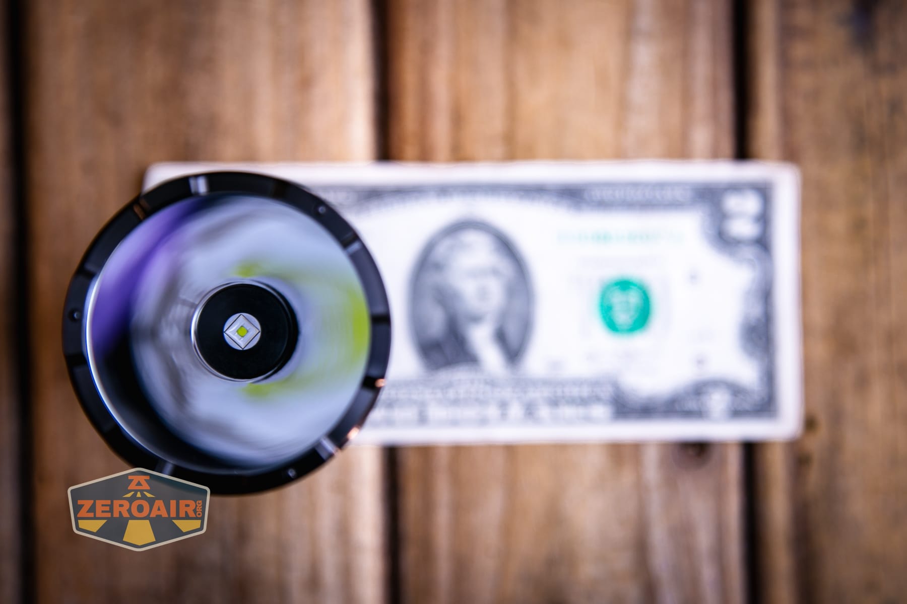 Niwalker N01 Max flashlight on a two dollar bill