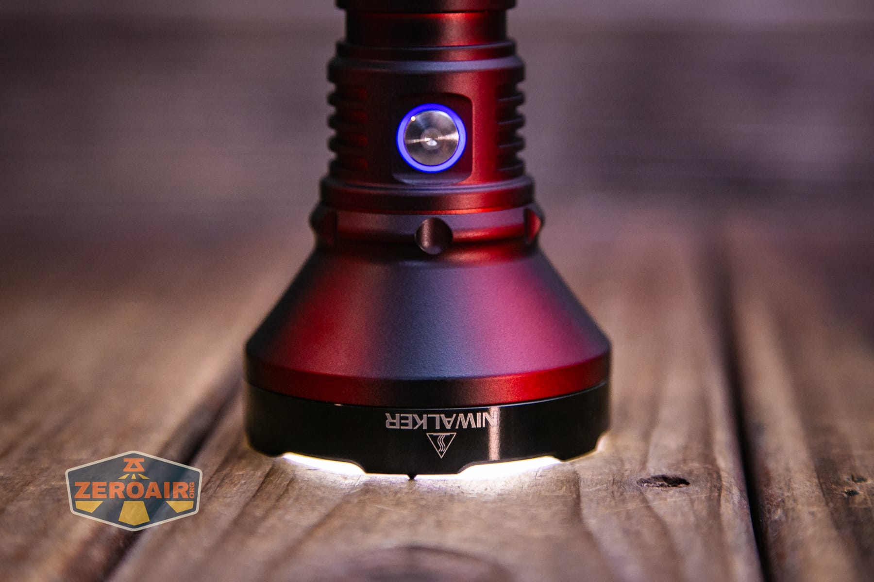 Niwalker N01 Max flashlight emitter on and headstanding and switch indicating in blue