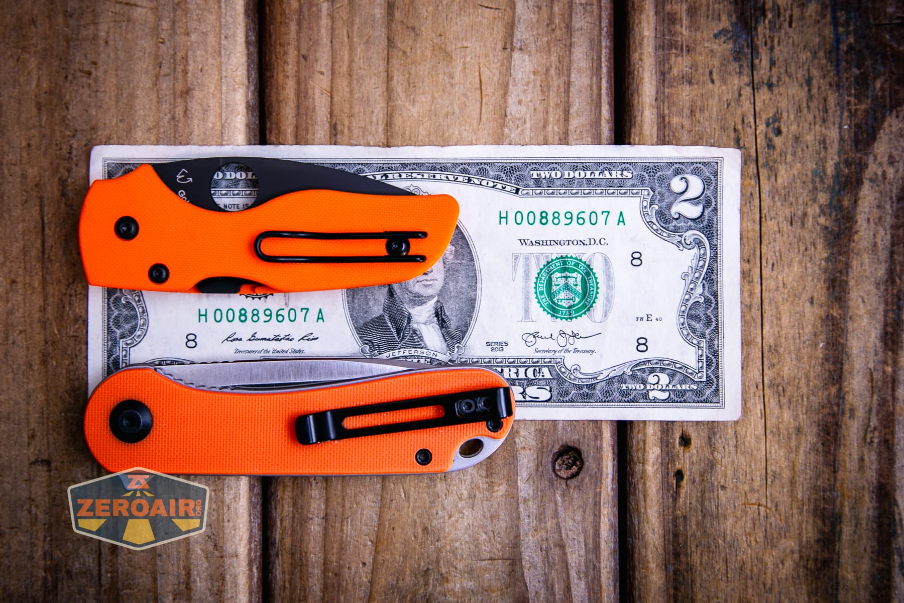 Spyderco Lil Native Cutlery Shoppe knife on a two dollar bill compared to Civivi Elementum in orange