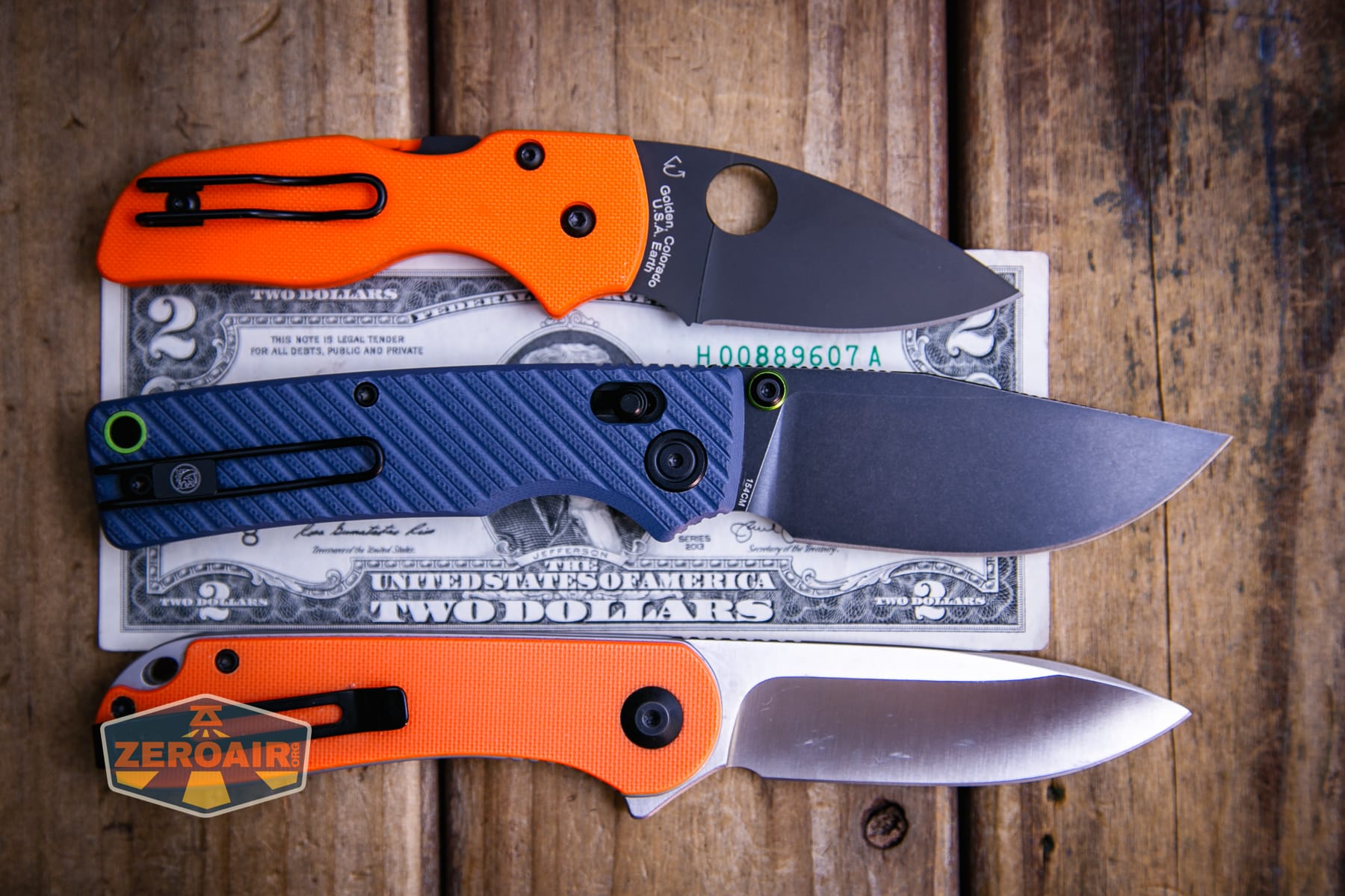 Vosteed Porcupine ModSwap Crossbar lock knife on a two dollar bill compared to Civivi Elementum in orange