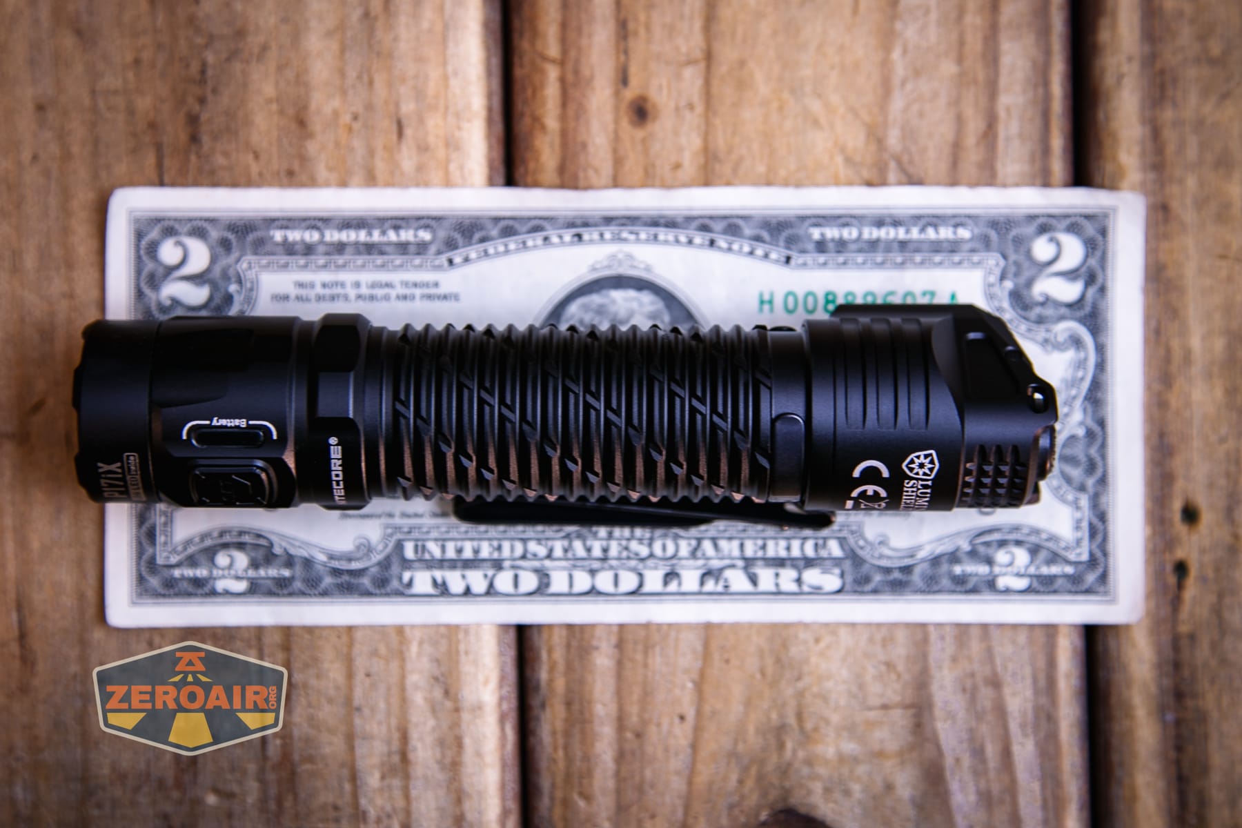 Nitecore P27iX customizable tactical flashlight on two dollar bill