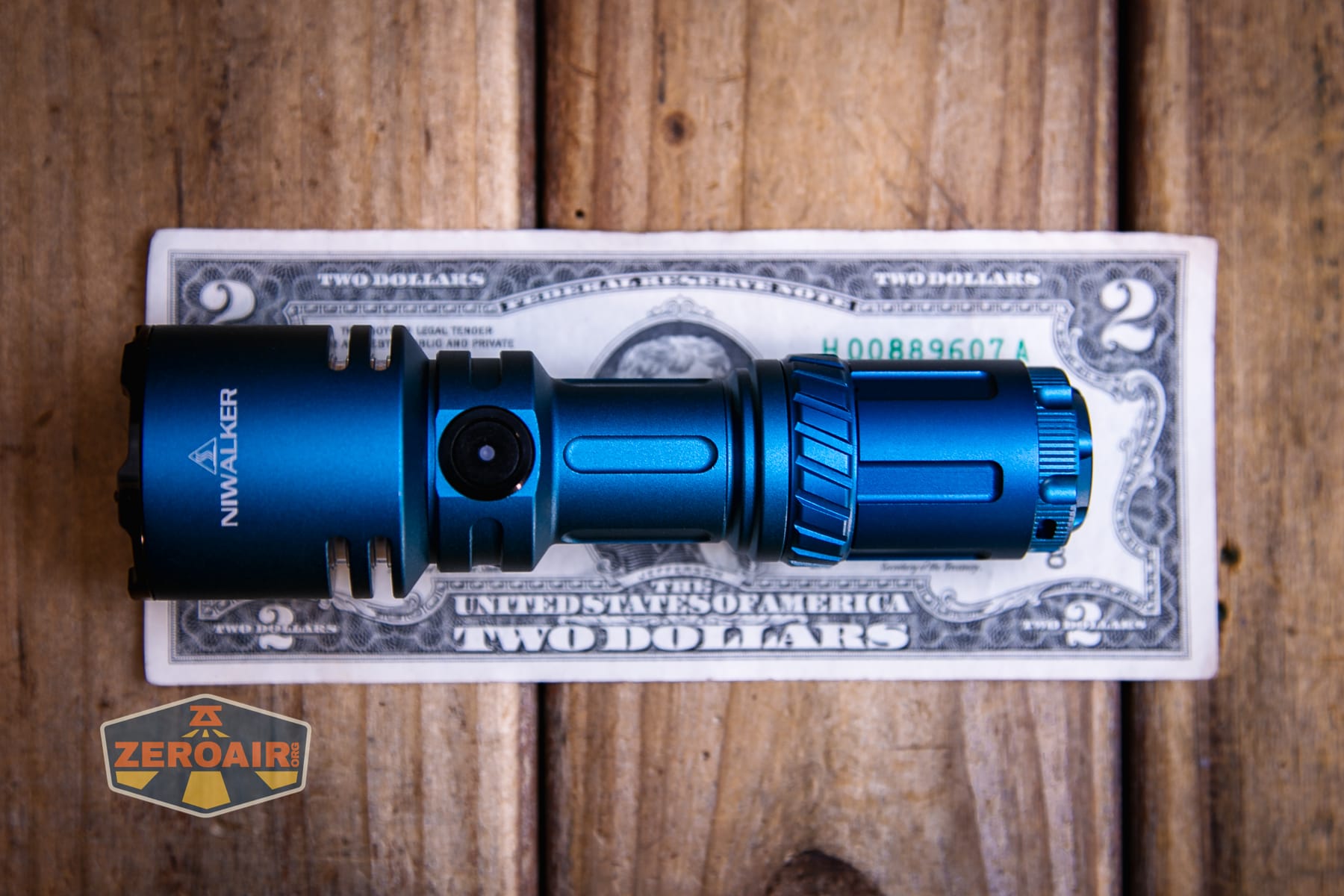 Niwalker N50S long range flashlight on two dollar bill