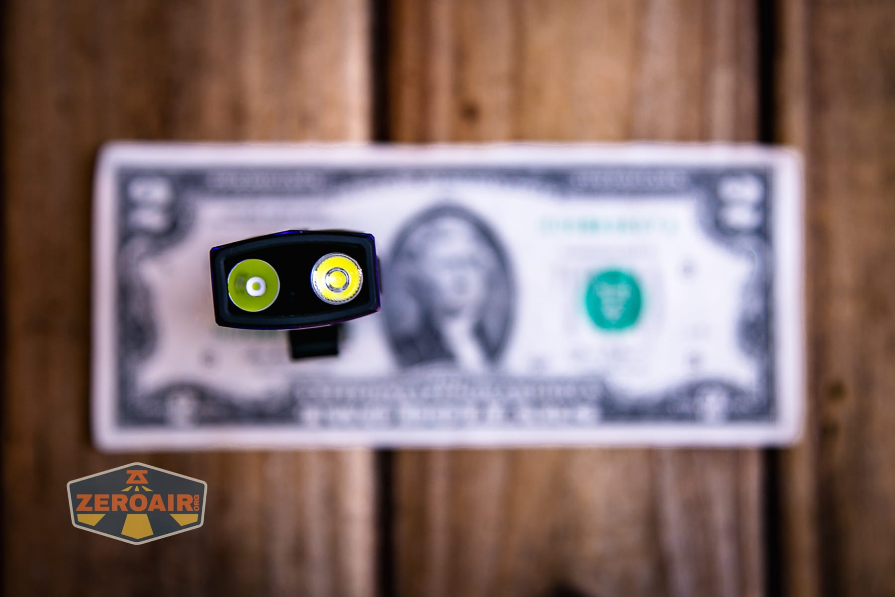 Olight ArkPro Nebula Violet Flat flashlight on a two dollar bill