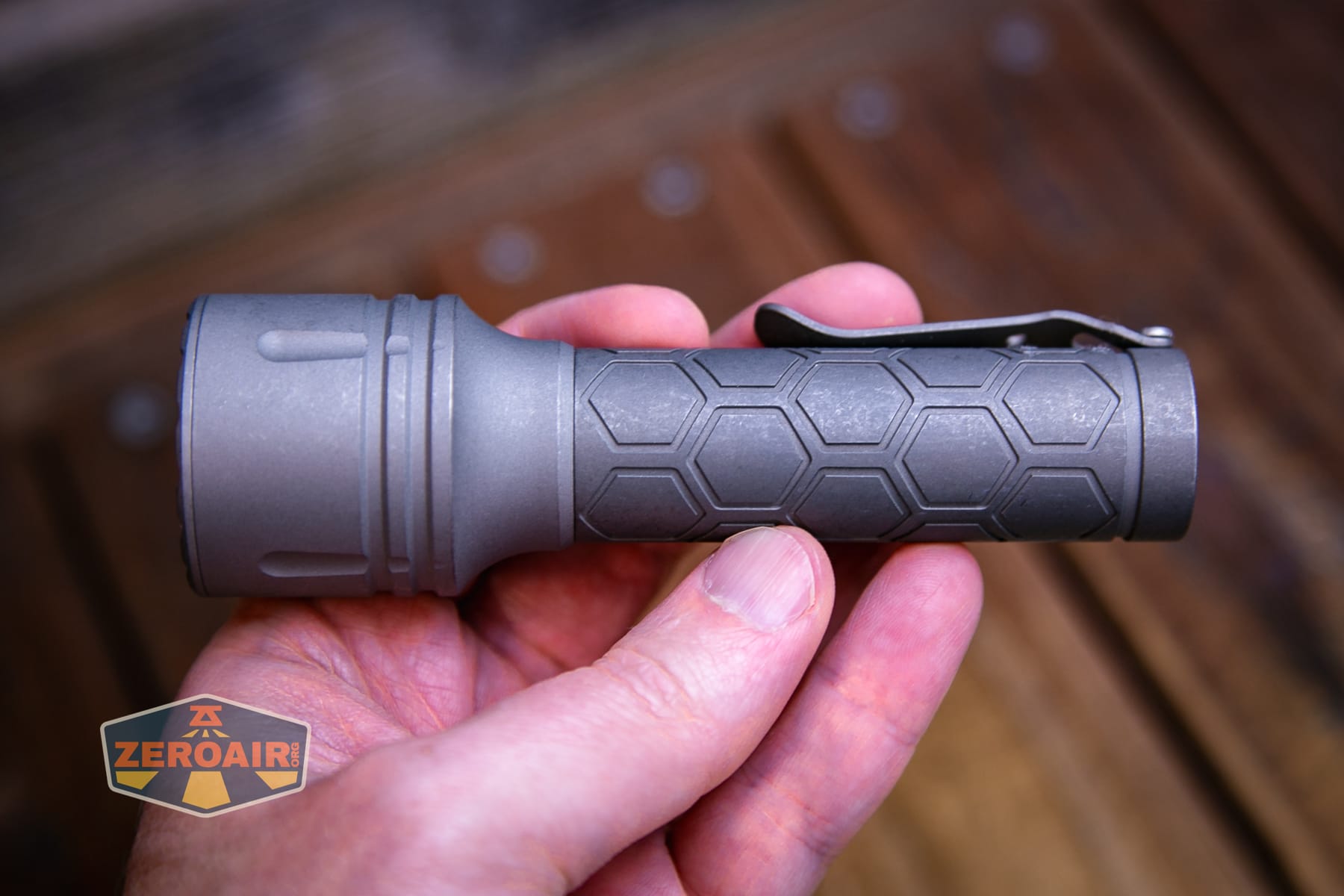 Reylight Dawn Max titanium flashlight in hand 18650