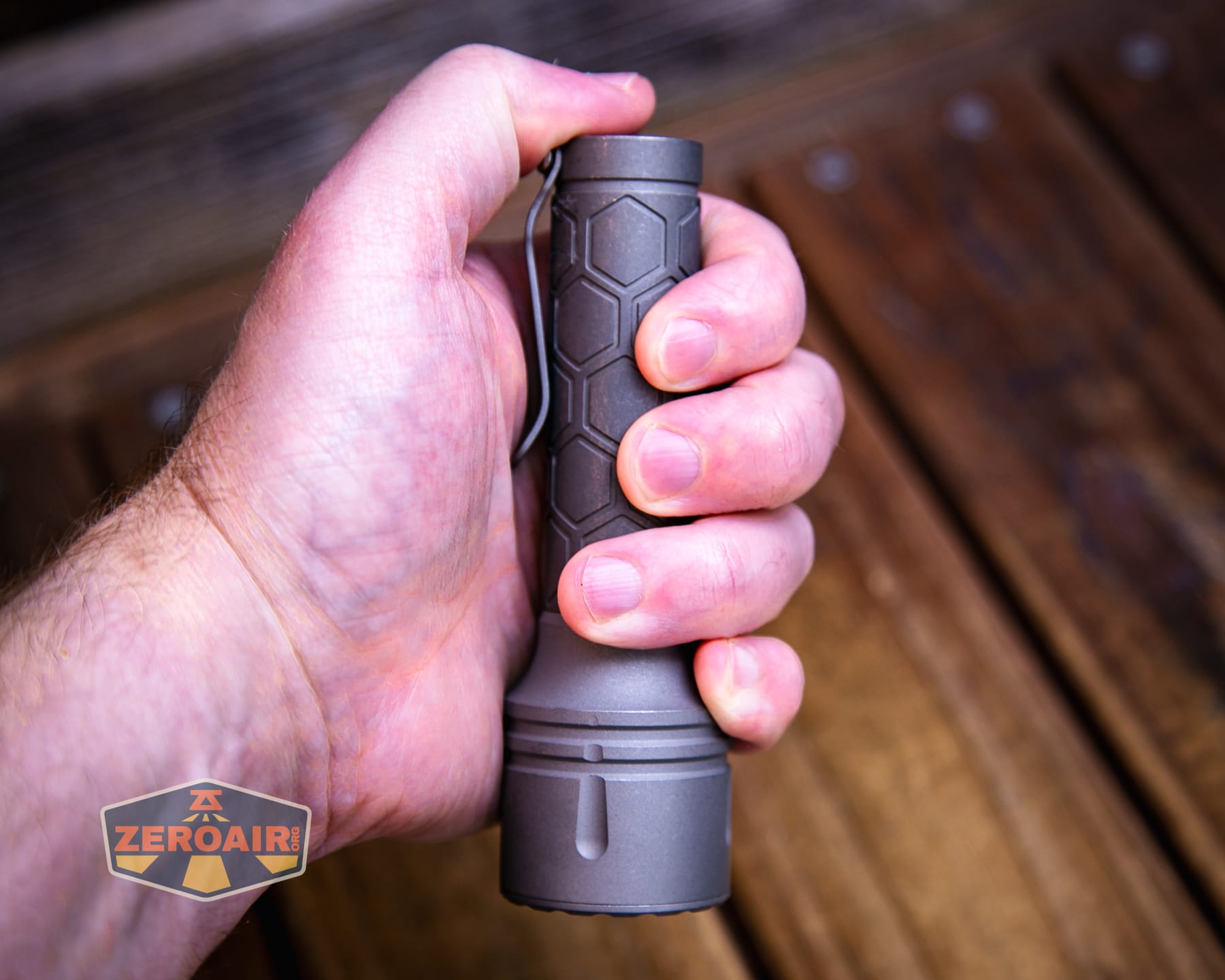 Reylight Dawn Max titanium flashlight in hand 18650