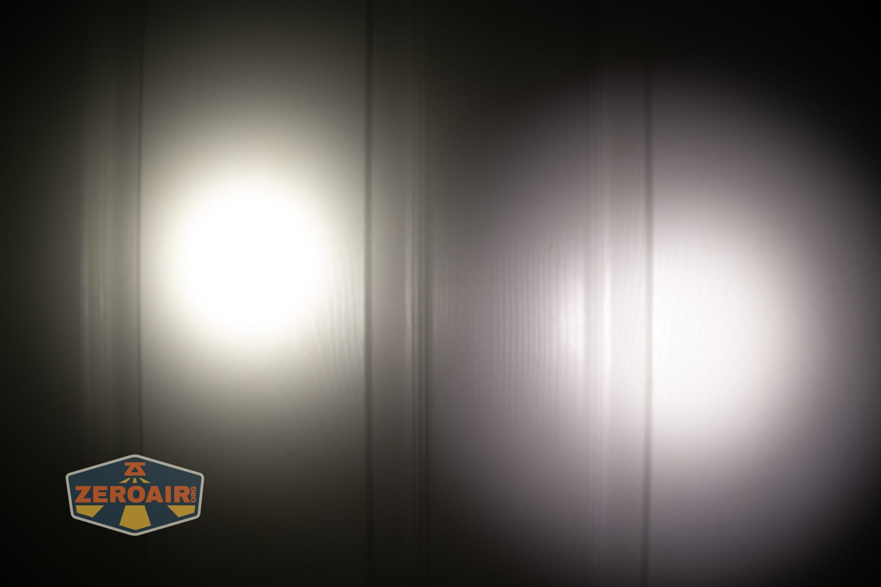 Reylight Dawn Max titanium flashlight beamshots on door (at 1') compared to nichia 219b 4500K
