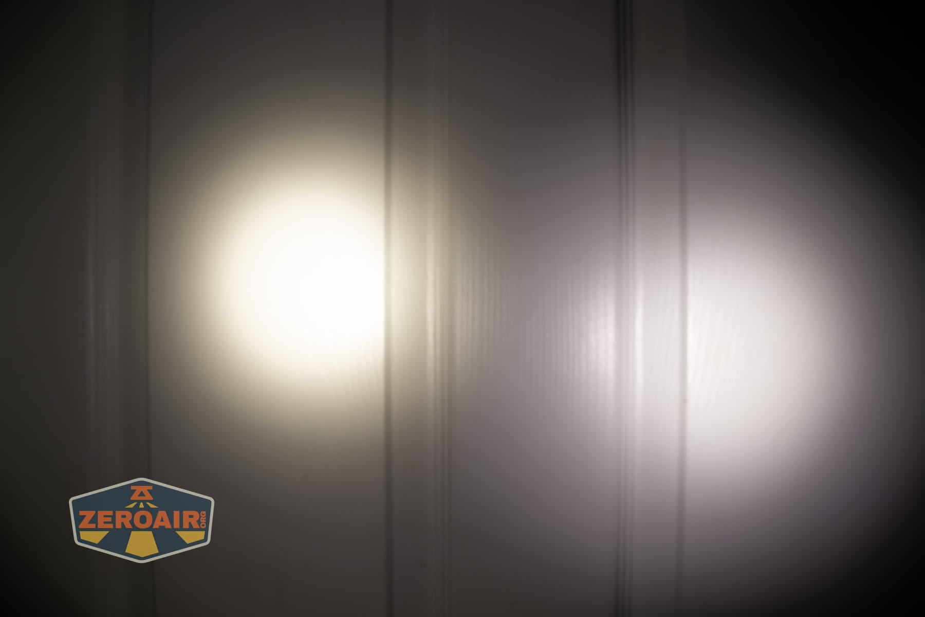 Skilhunt M150 V4 flashlight beamshots on door compared to nichia 219b