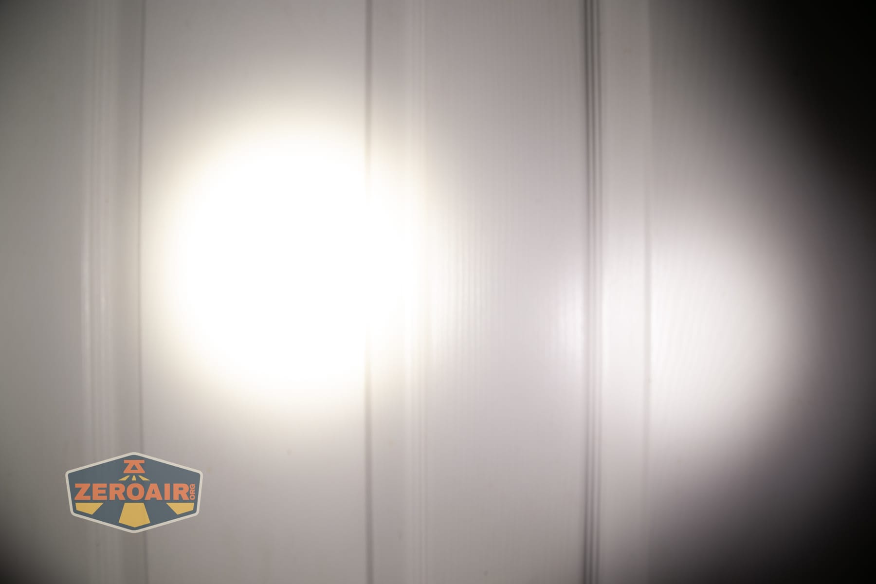 Skilhunt M150 V4 flashlight beamshots on door compared to nichia 219b