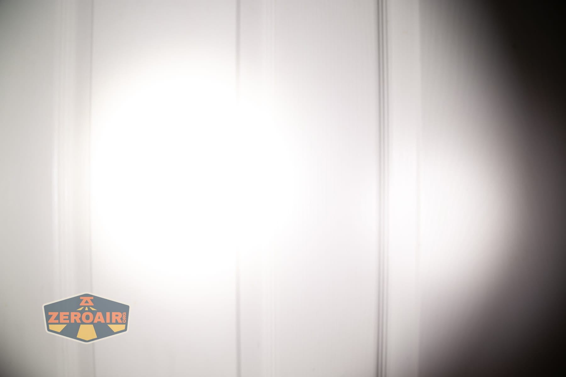 Skilhunt M150 V4 flashlight beamshots on door compared to nichia 219b