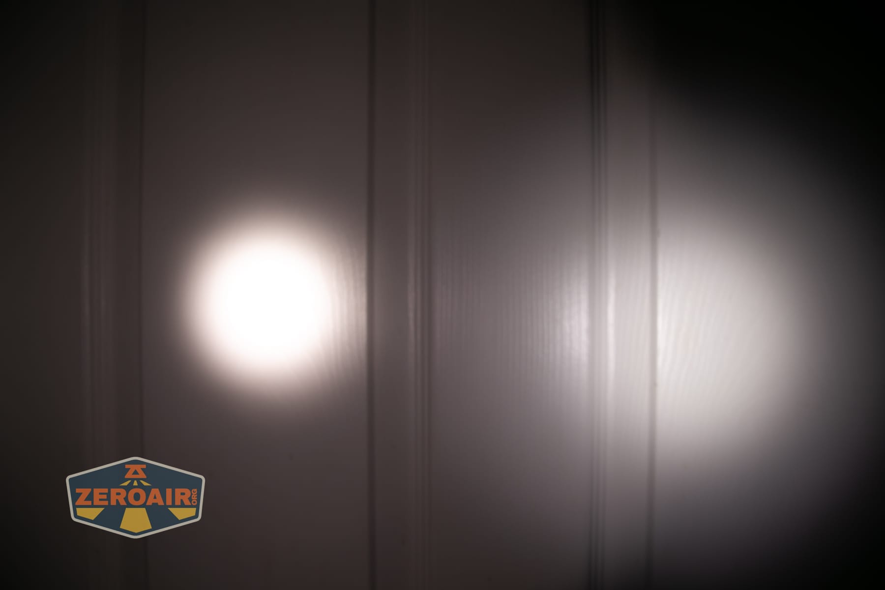 Skilhunt M150 V4 flashlight beamshots on door compared to nichia 219b