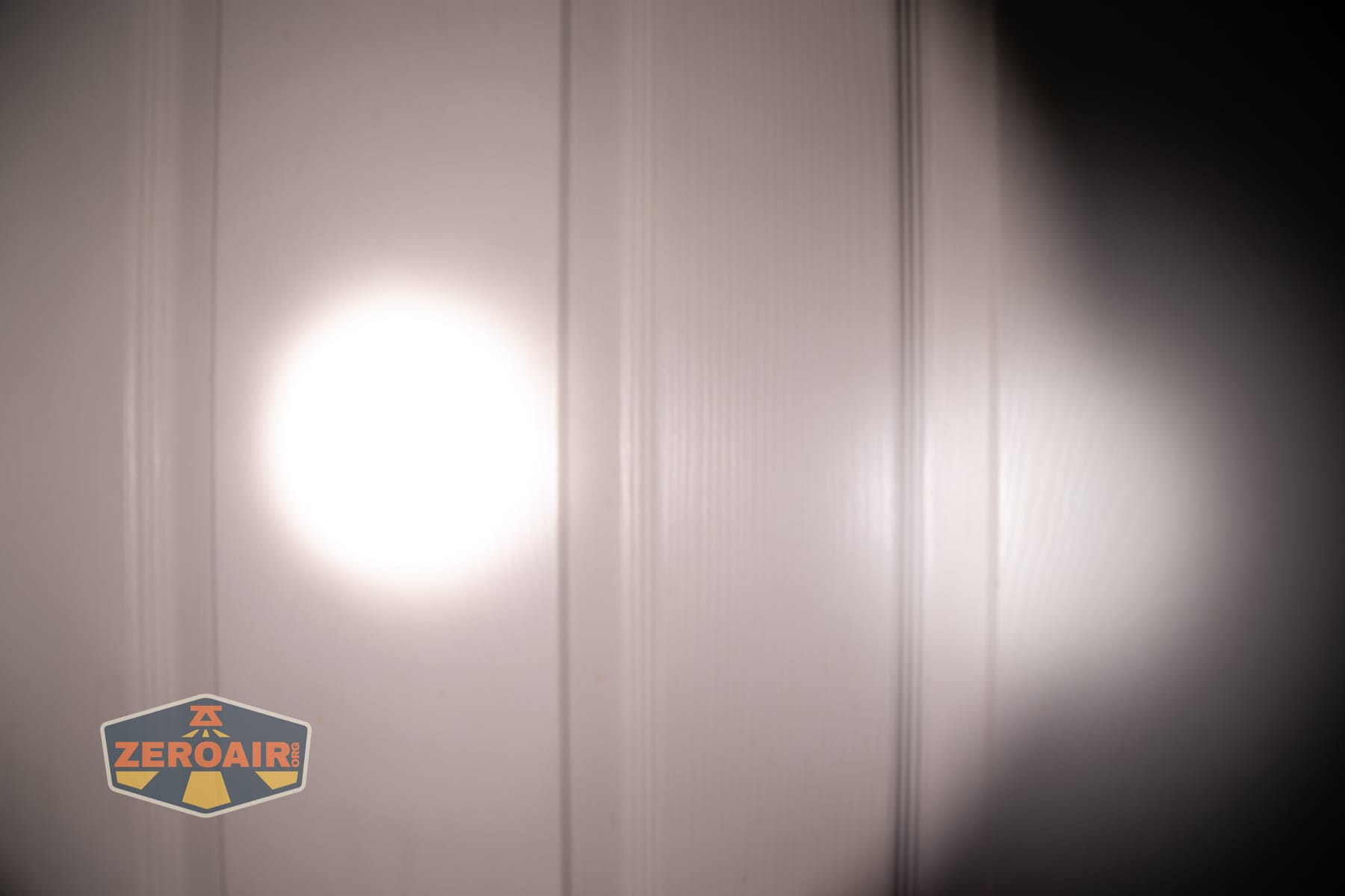 Skilhunt M150 V4 flashlight beamshots on door compared to nichia 219b