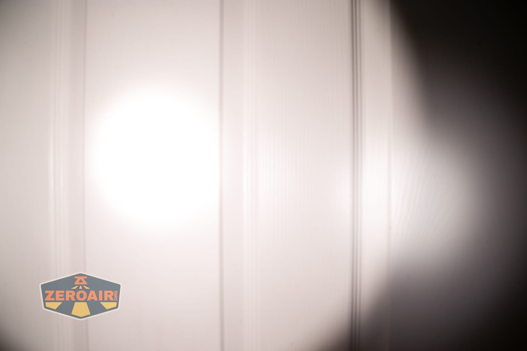 Skilhunt M150 V4 flashlight beamshots on door compared to nichia 219b
