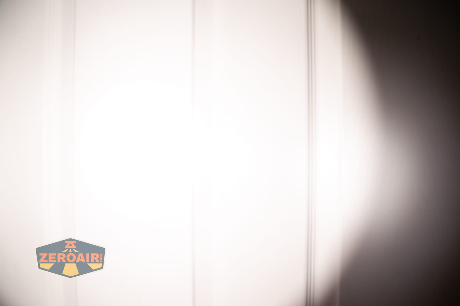 Skilhunt M150 V4 flashlight beamshots on door compared to nichia 219b