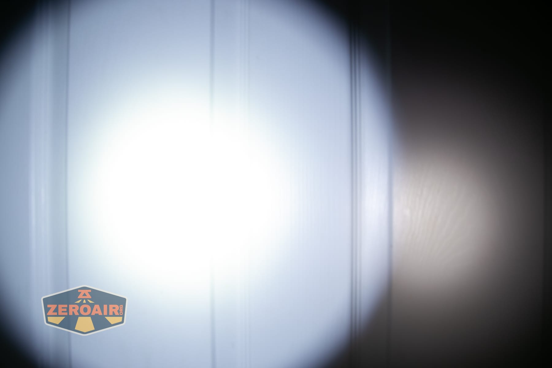 Trustfire T25R tactical flashlight beamshots on door (at 1') compared to nichia 219b 4500K