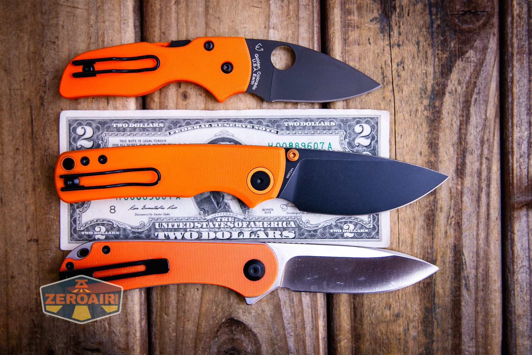 Vosteed Porcupine G10 Orange knife on a two dollar bill compared to Civivi Elementum in orange