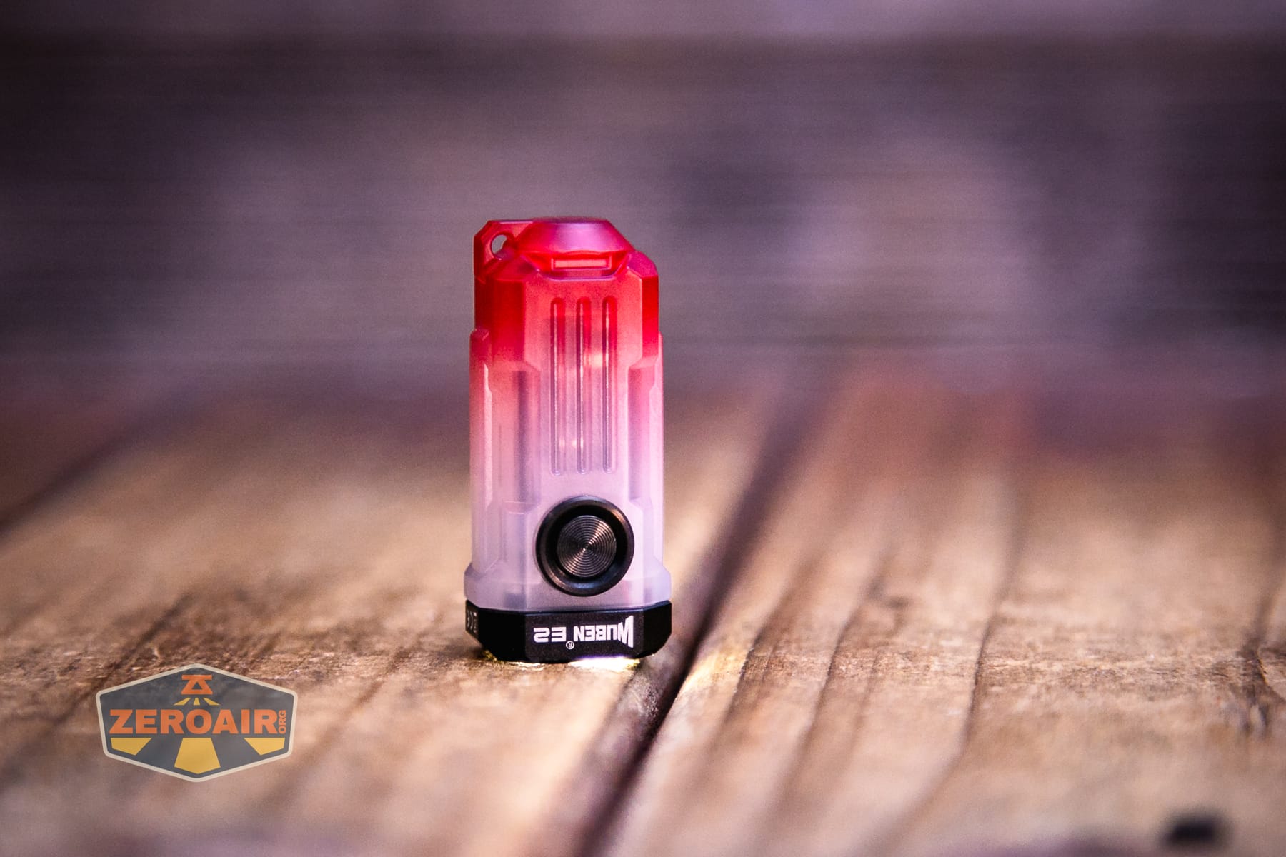 Wuben E2 Pulse keychain flashlight emitter on and headstanding