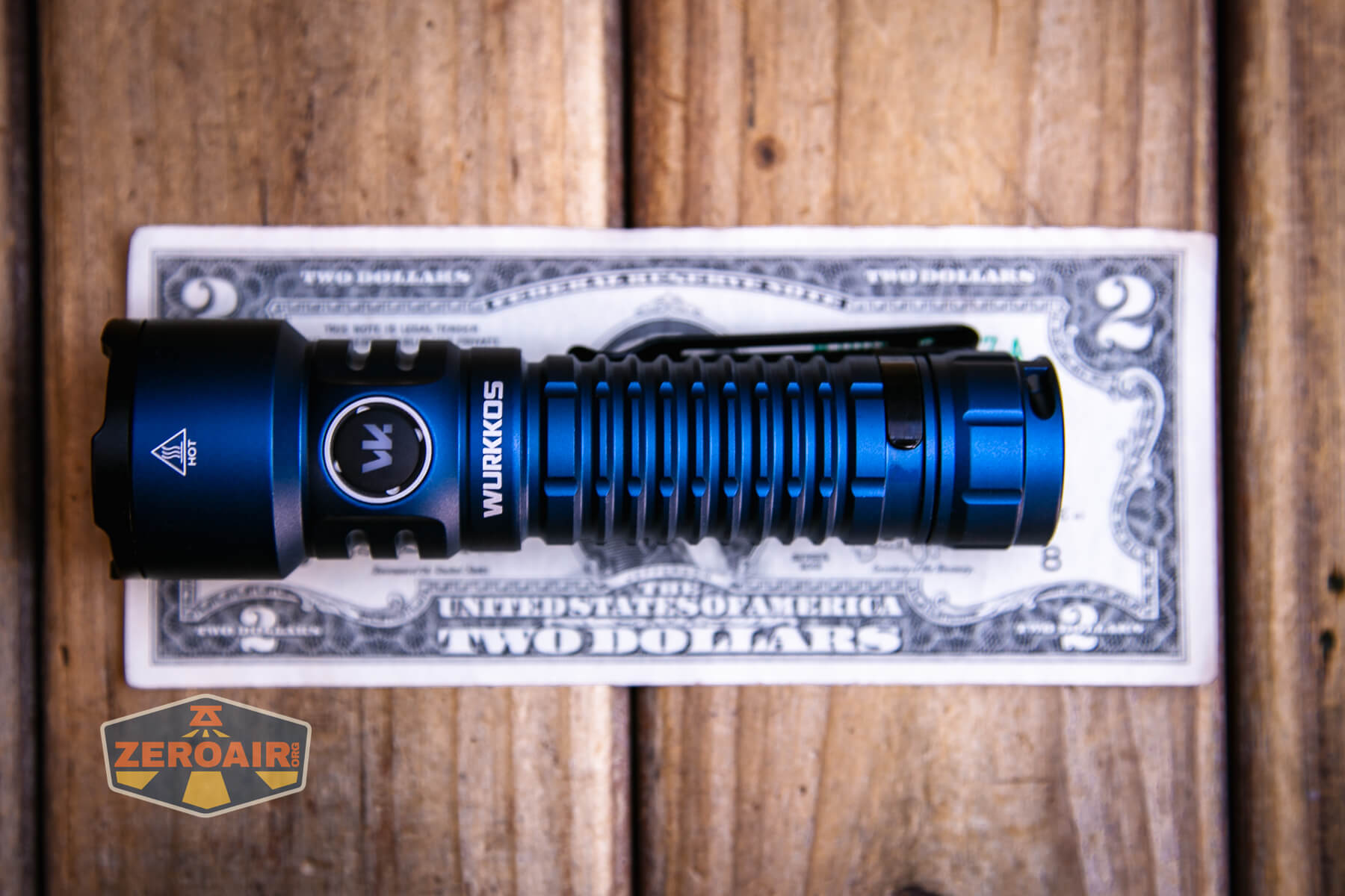Wurkkos TS28 blue flashlight on two dollar bill