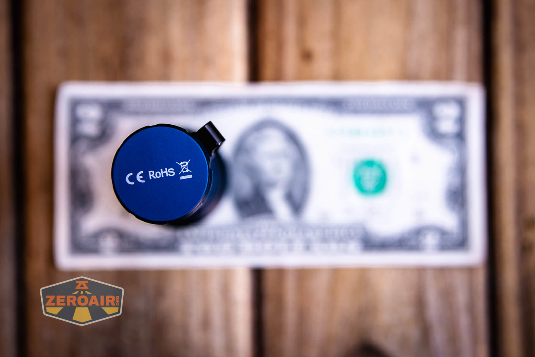 Wurkkos TS28 blue flashlight on two dollar bill