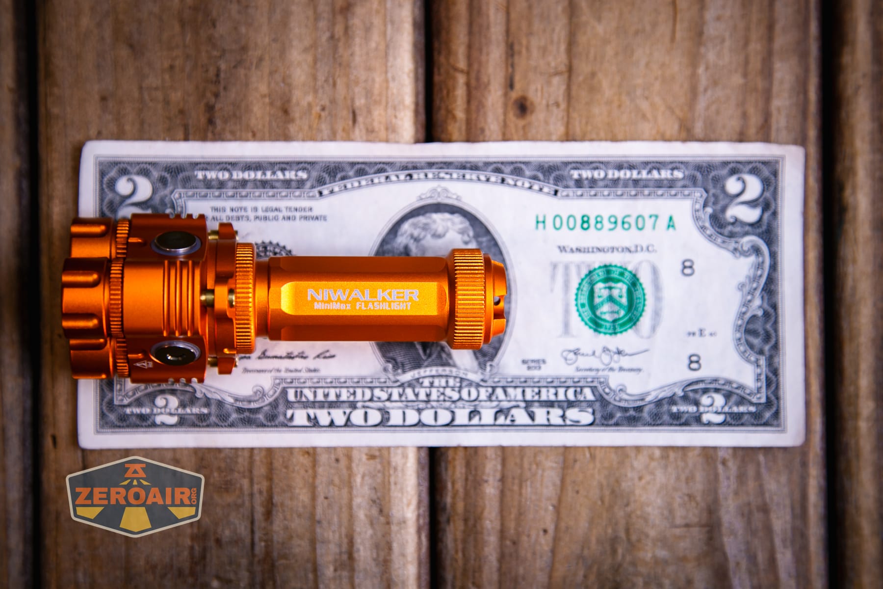 Niwalker ES01 Three Light flashlight on a two dollar bill