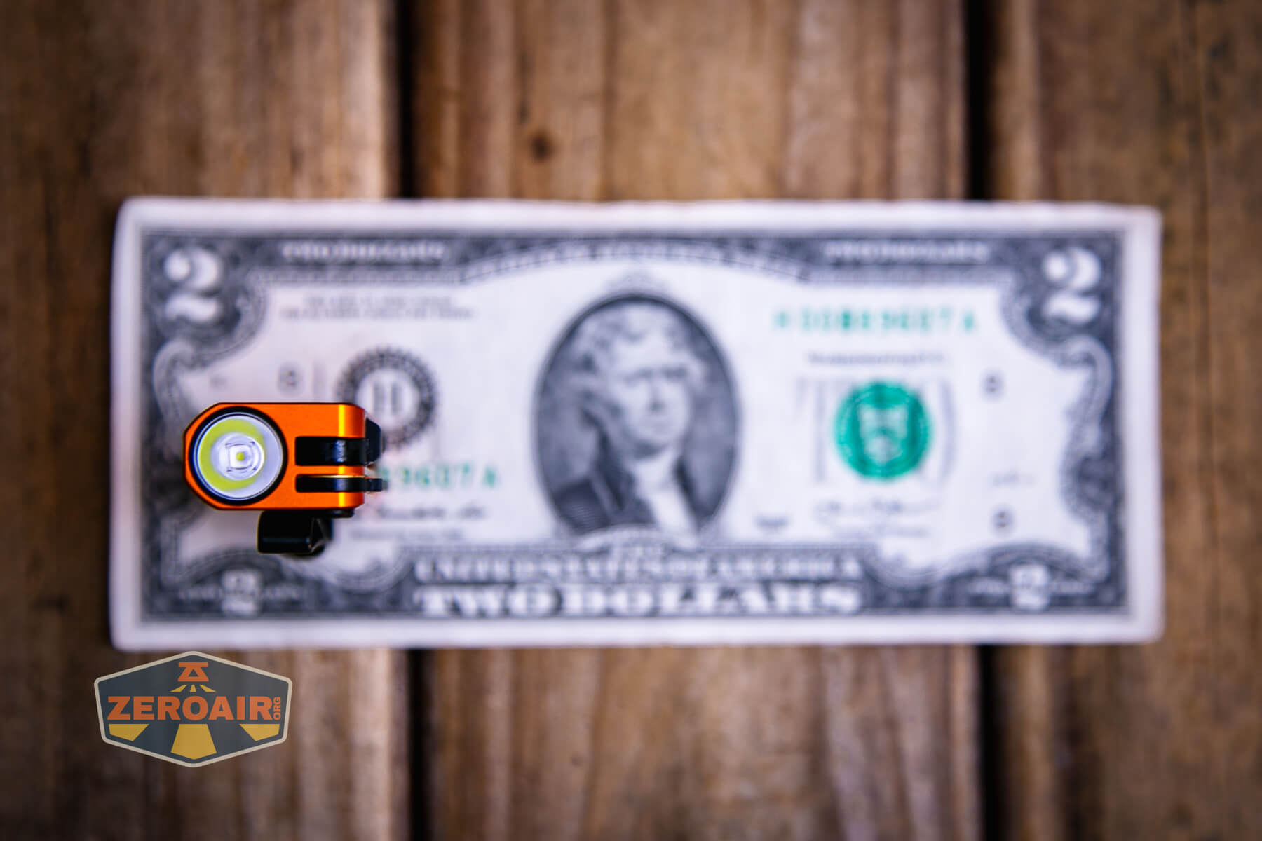 Olight Oknife MK on a two dollar bill