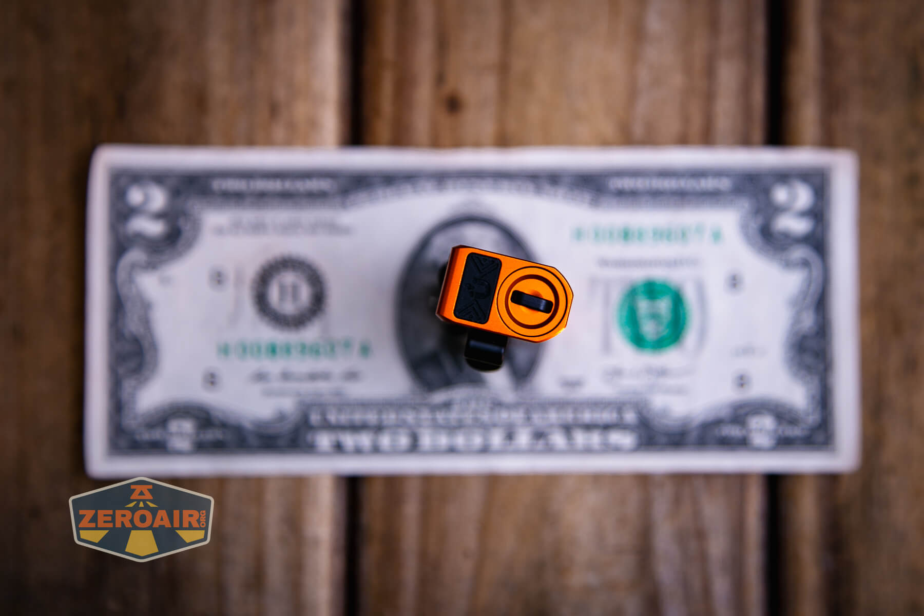 Olight Oknife MK on a two dollar bill