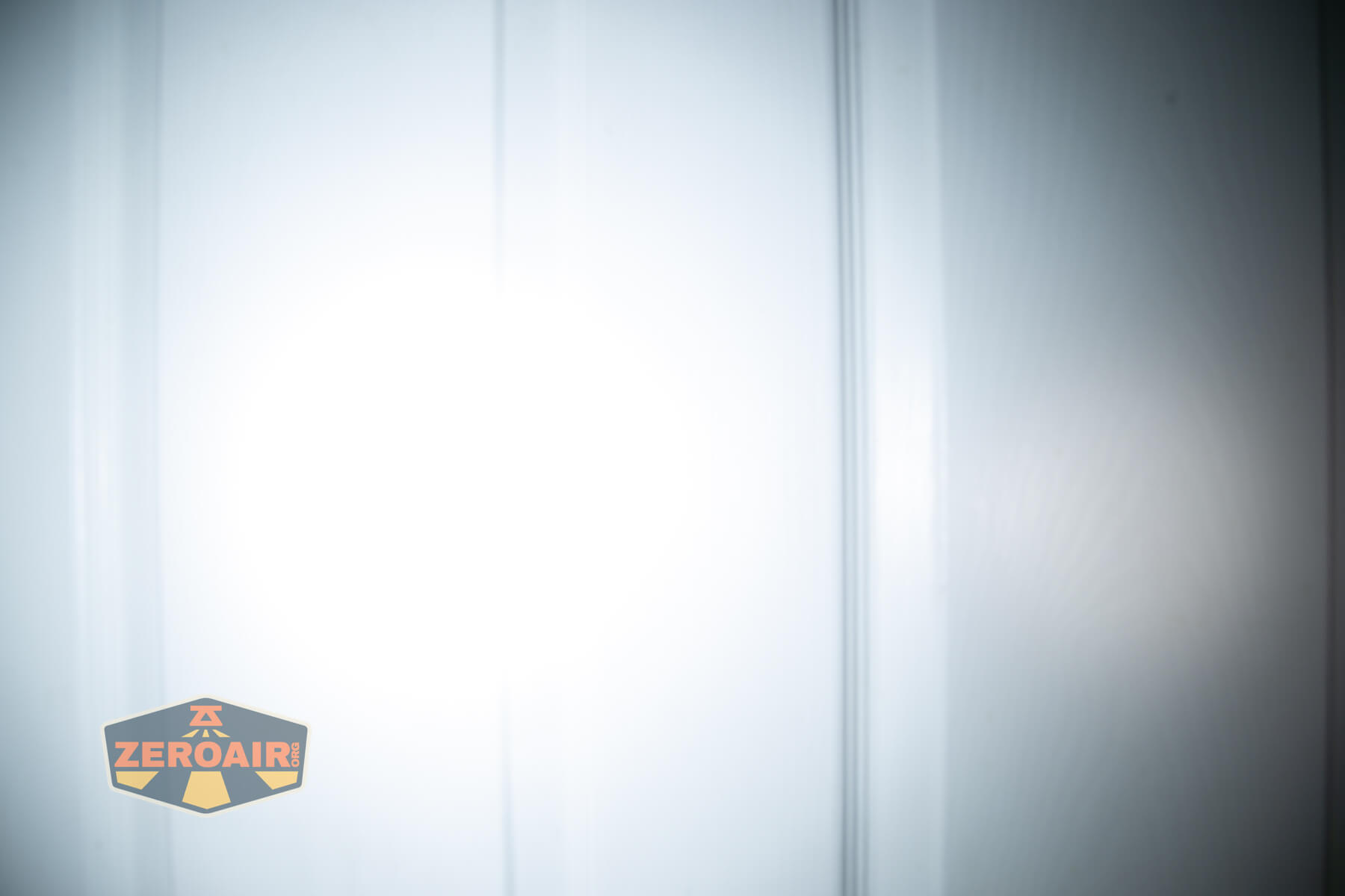 Olight Oknife MK beamshots on door (at 1') compared to nichia 219b 4500K