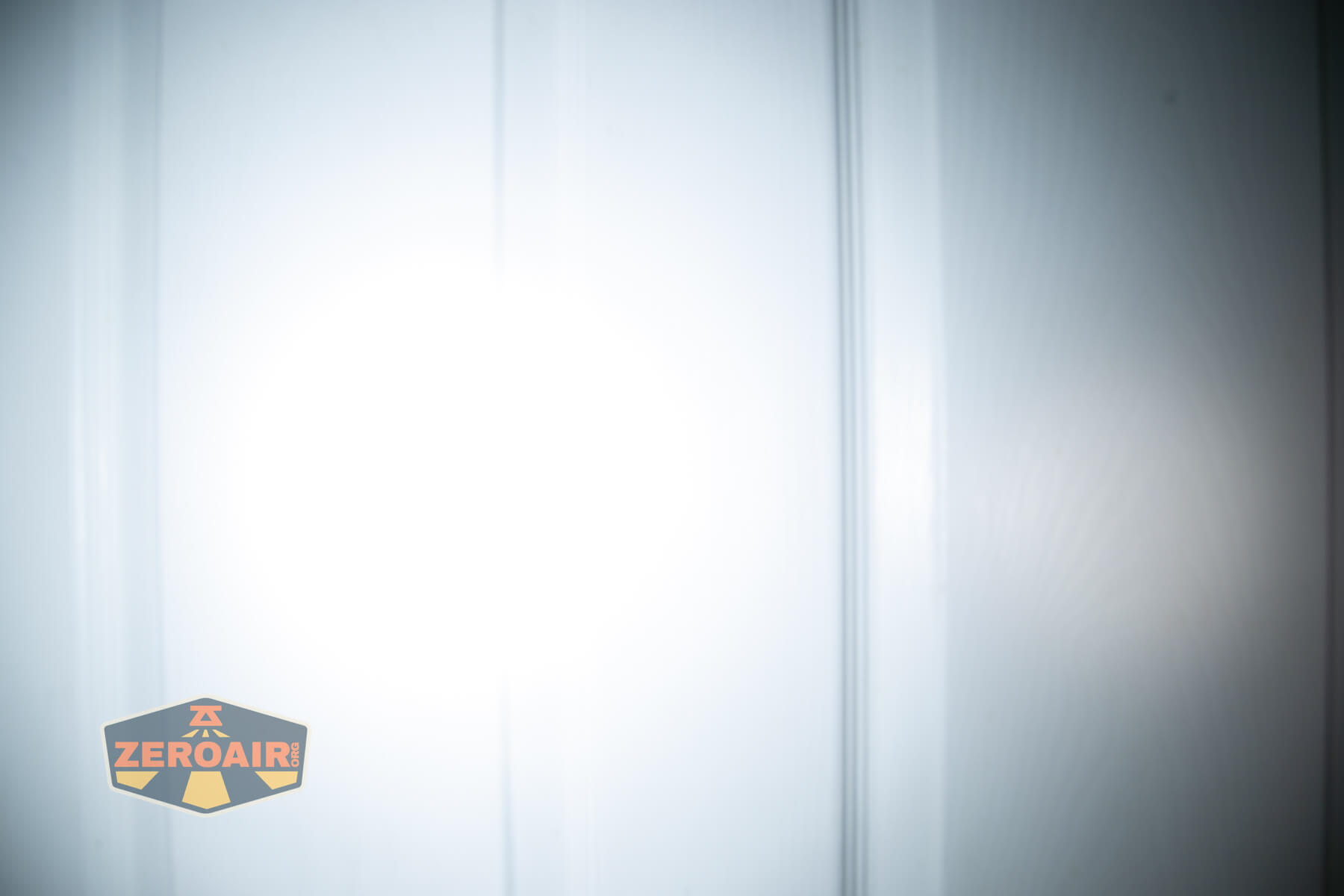 Olight Oknife MK beamshots on door (at 1') compared to nichia 219b 4500K