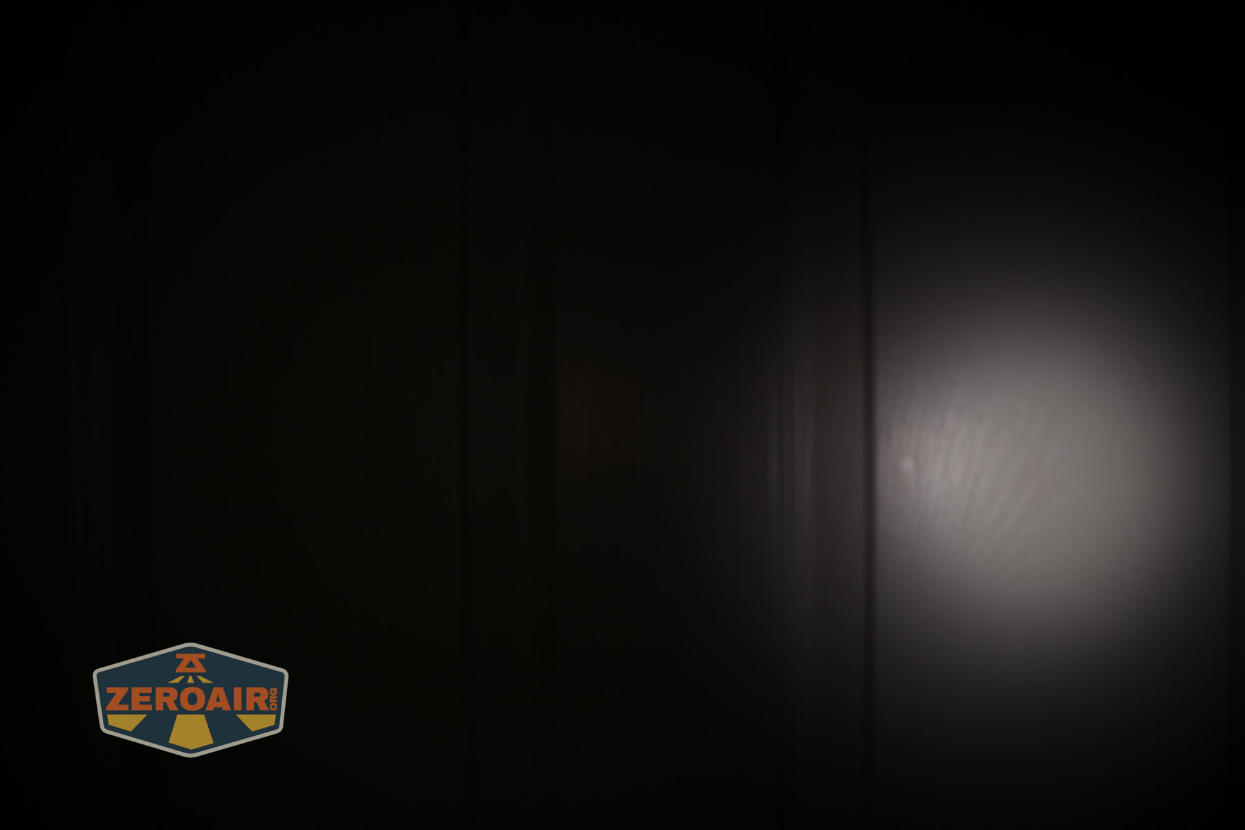 Olight Oknife MK beamshots on door (at 1') compared to nichia 219b 4500K