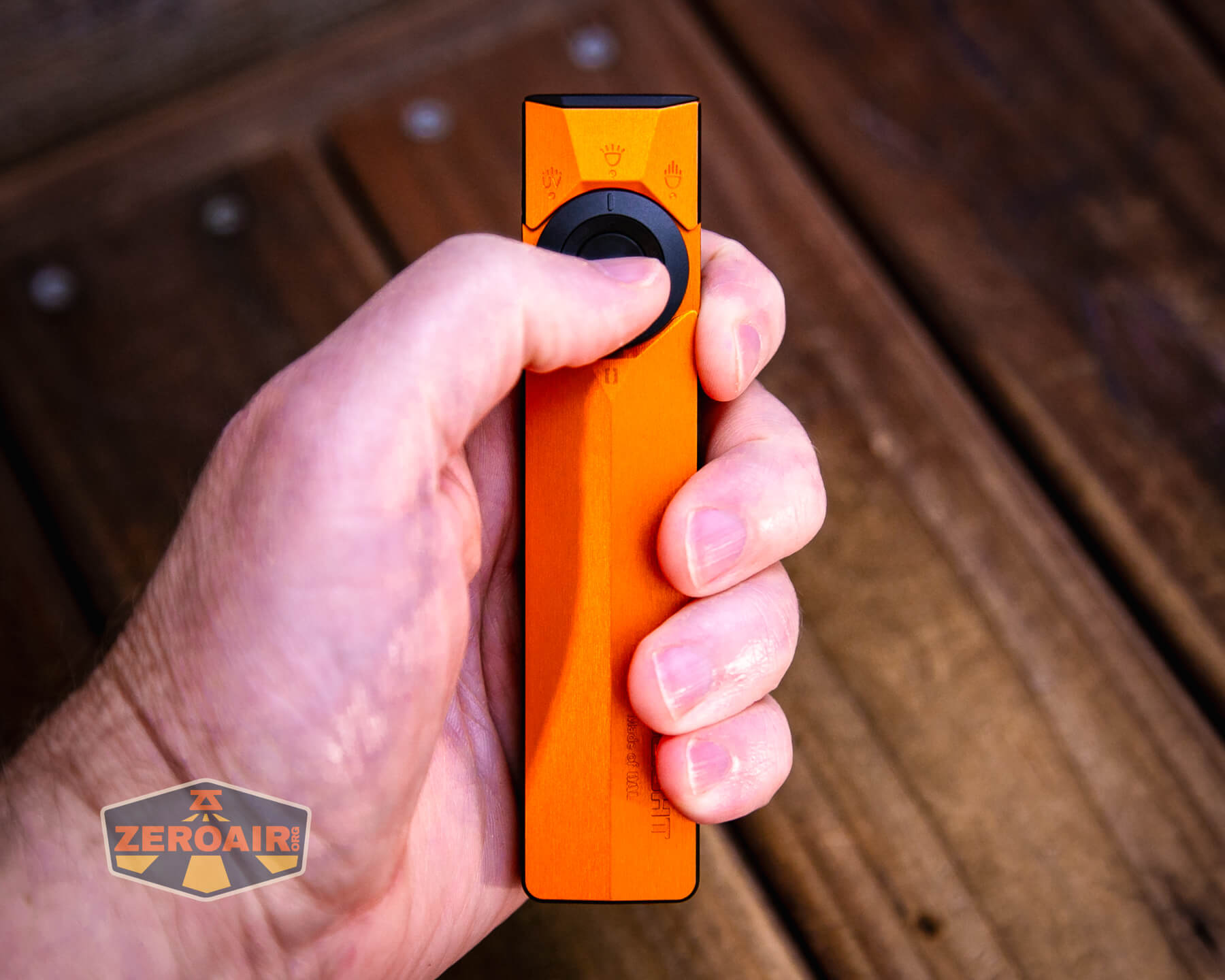 Olight ArkPro Ultra Orange flat EDC flashlight in hand