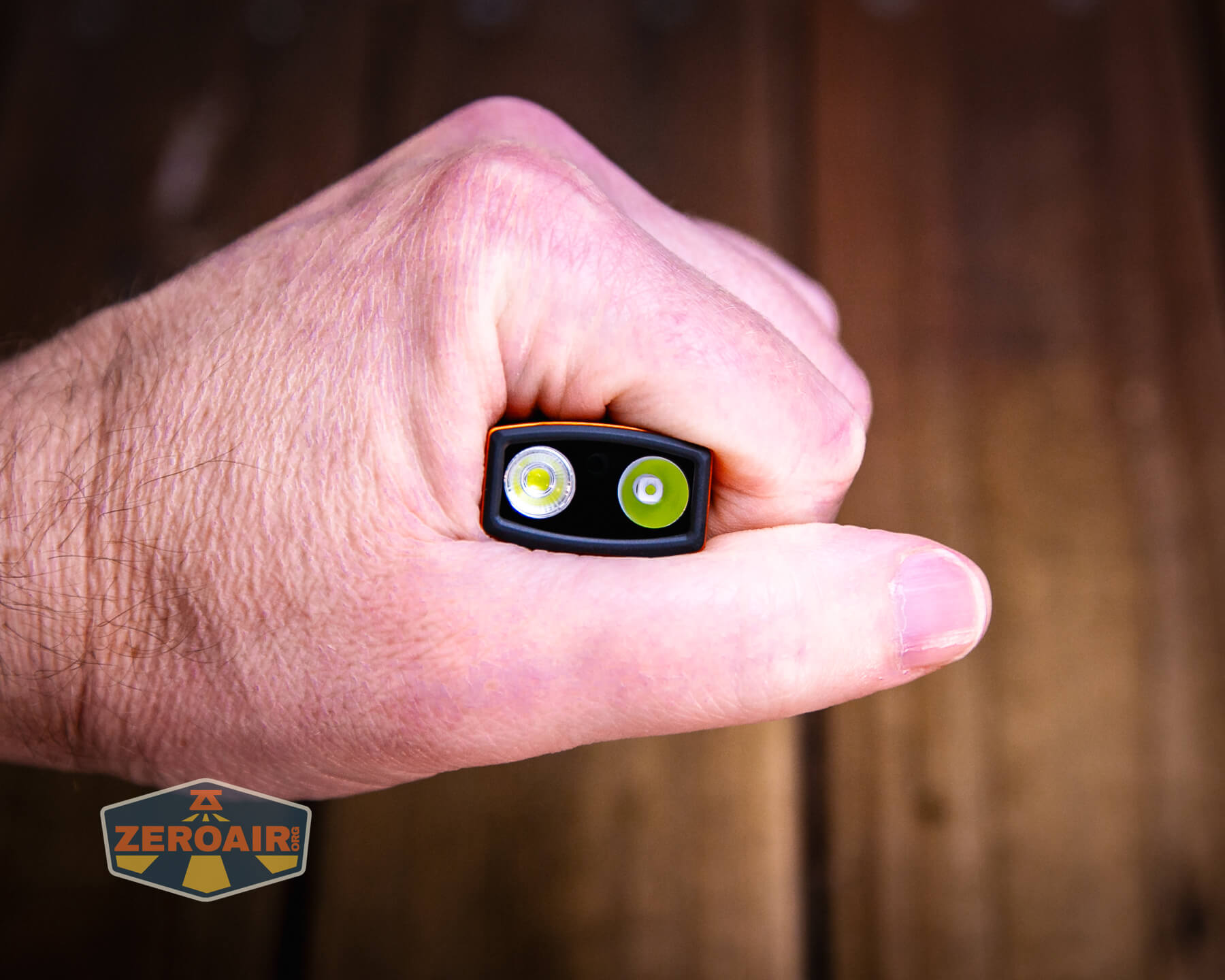 Olight ArkPro Ultra Orange flat EDC flashlight in hand