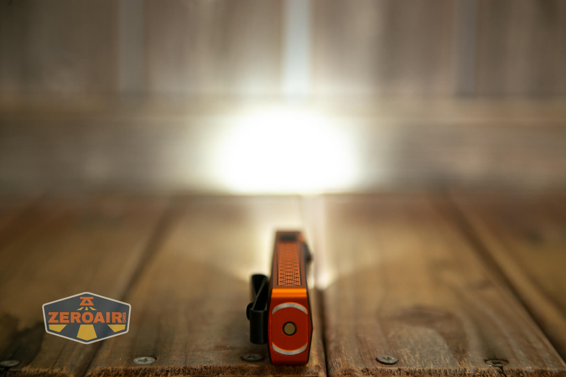 Olight ArkPro Ultra Orange flat EDC flashlight front white emitter on