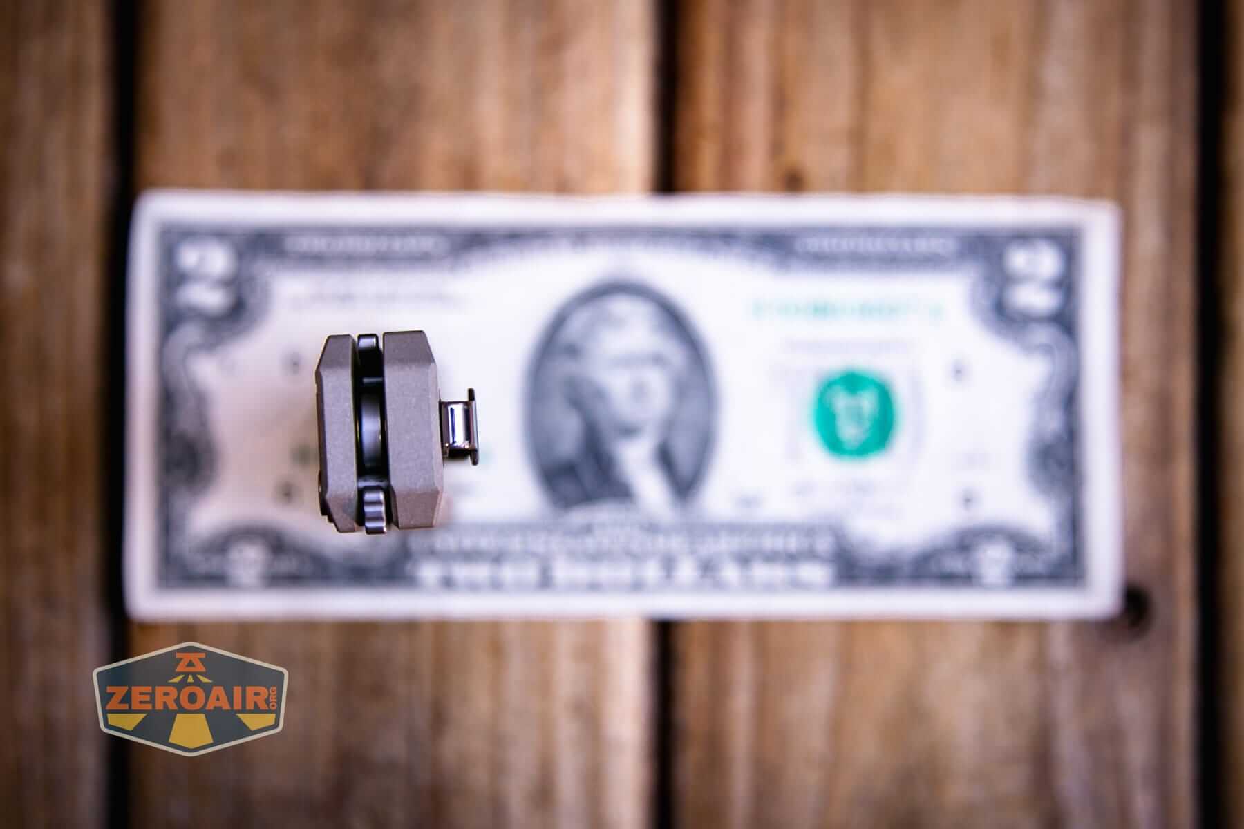 Olight Oknife LK folding knife flashlight on a two dollar bill
