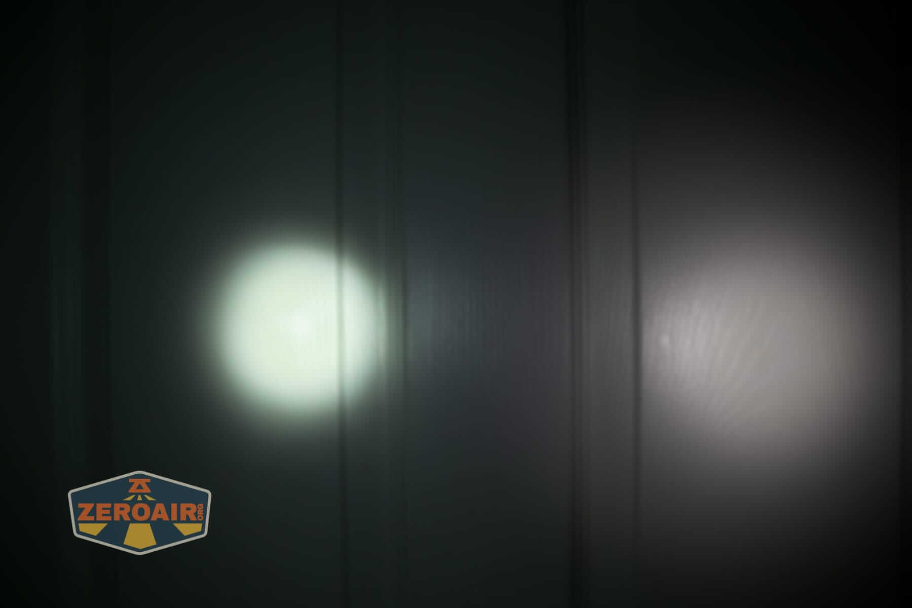 Olight Oknife LK folding knife flashlight beamshots on door (at 1') compared to nichia 219b 4500K