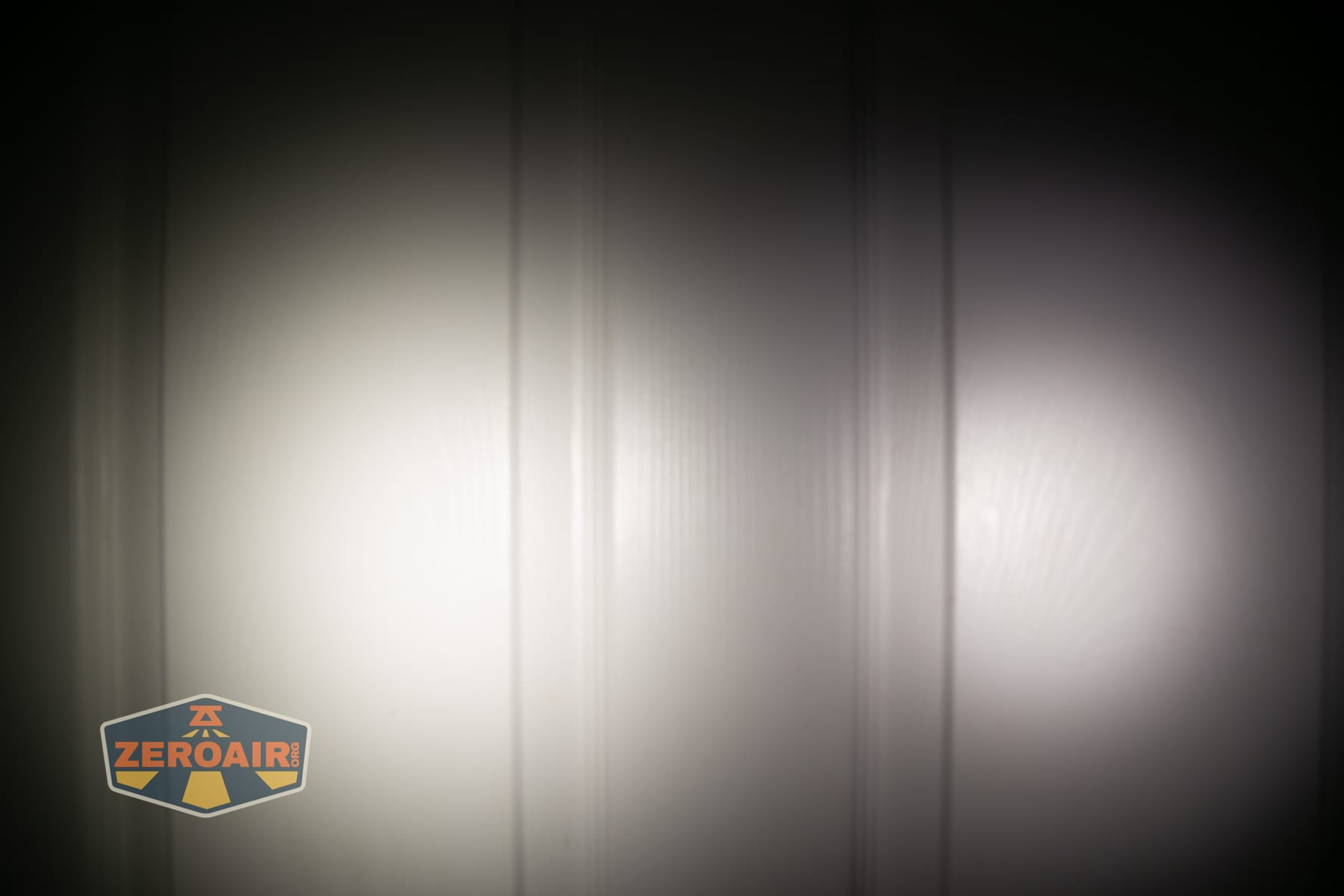 Skilhunt H150V4 5000K headlamp beamshots on door (at 1') compared to nichia 219b 4500K