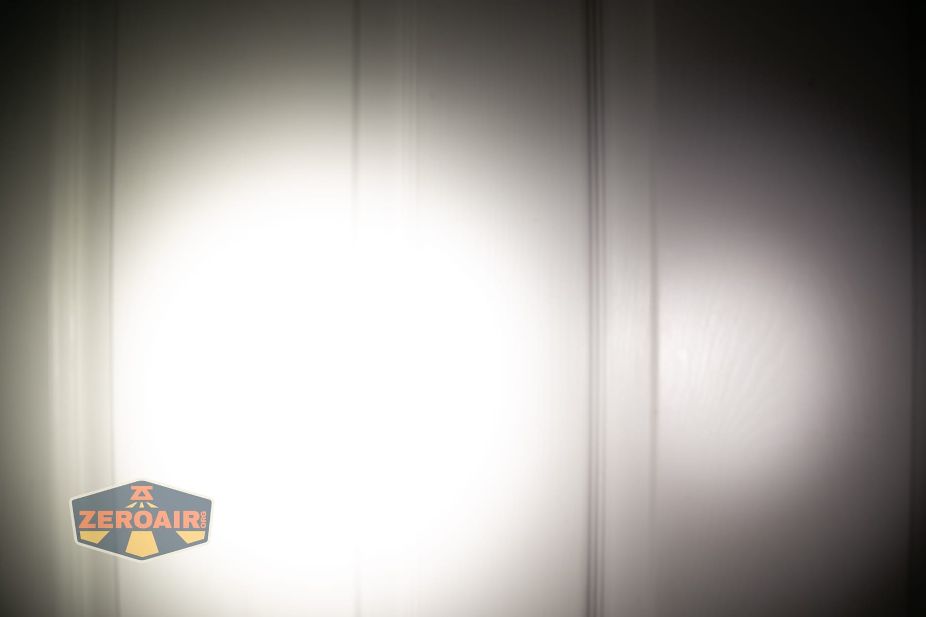 Skilhunt H150V4 5000K headlamp beamshots on door (at 1') compared to nichia 219b 4500K