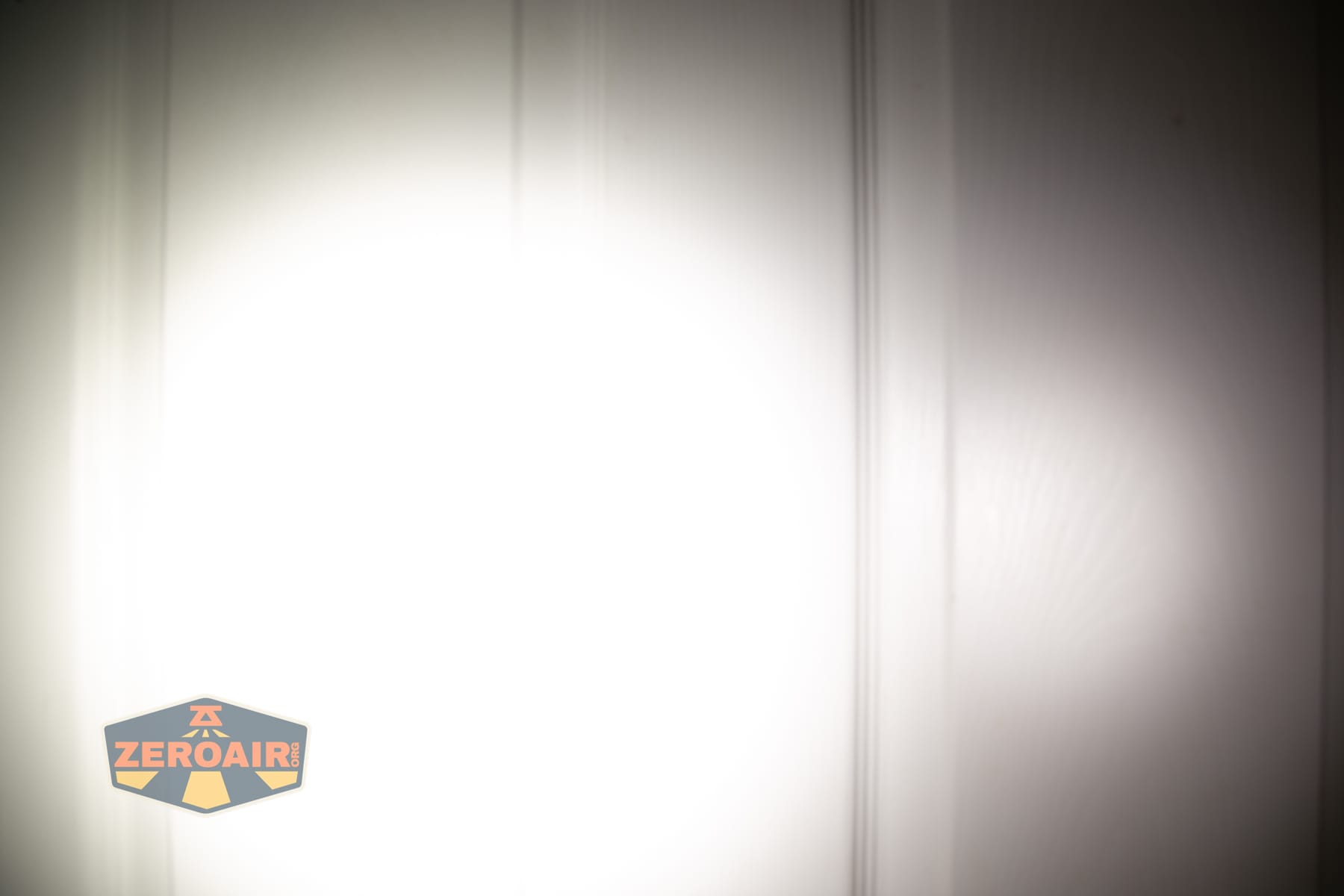 Skilhunt H150V4 5000K headlamp beamshots on door (at 1') compared to nichia 219b 4500K