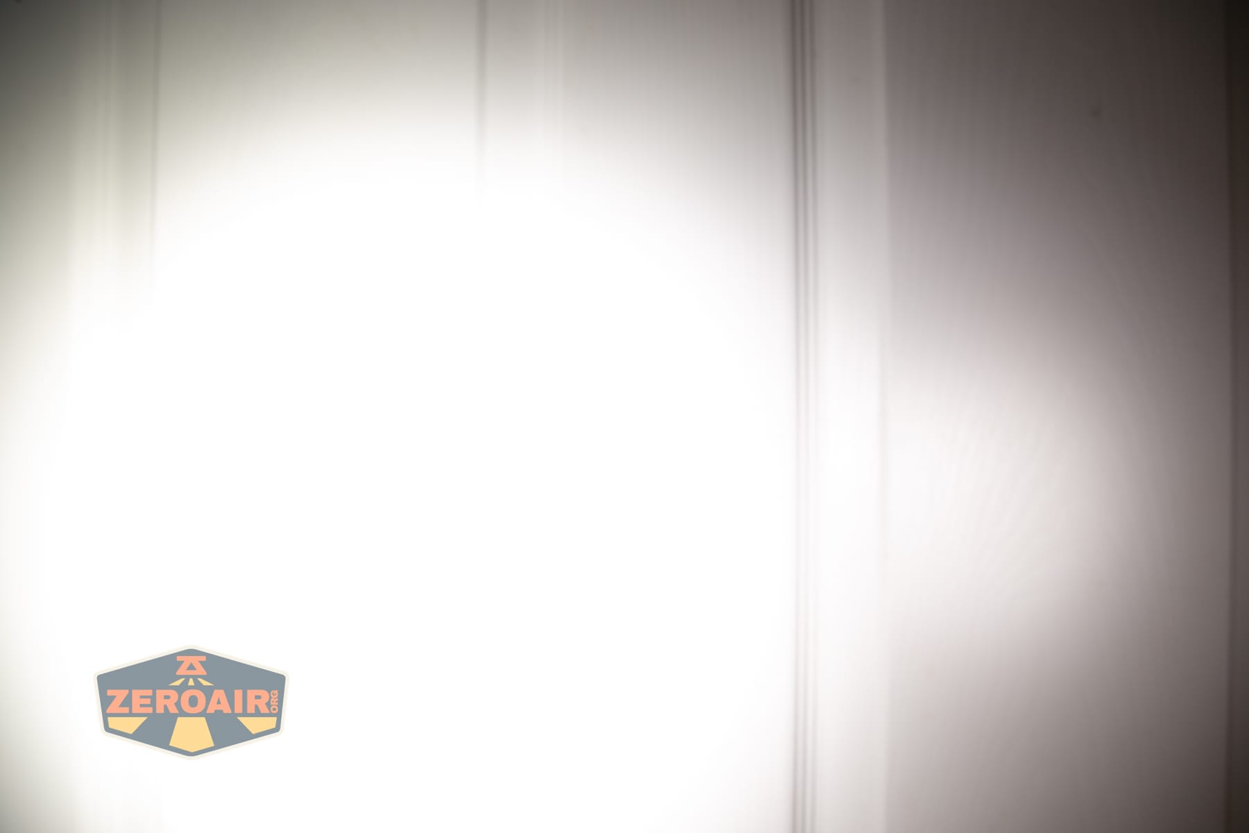 Skilhunt H150V4 5000K headlamp beamshots on door (at 1') compared to nichia 219b 4500K