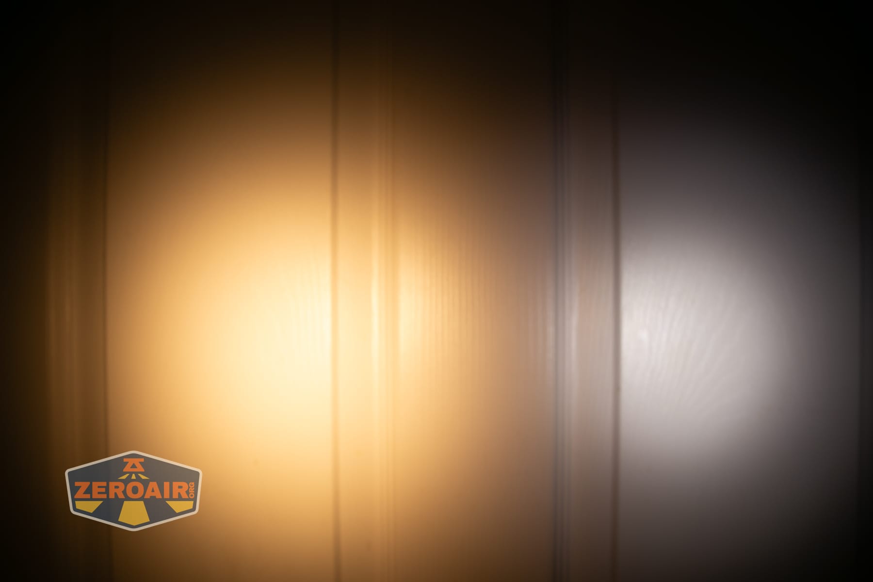 Skilhunt H150V4 3000K headlamp beamshots on door (at 1') compared to nichia 219b 4500K