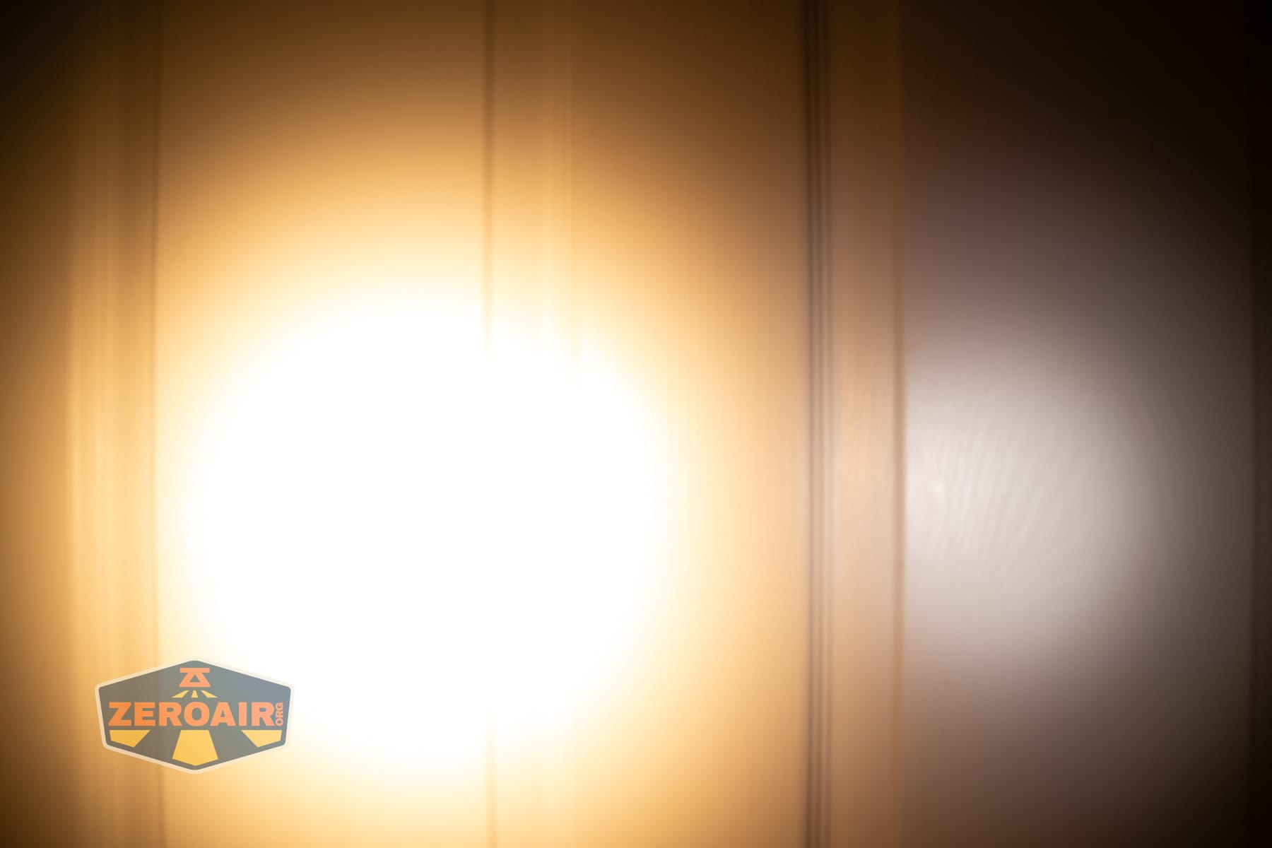 Skilhunt H150V4 3000K headlamp beamshots on door (at 1') compared to nichia 219b 4500K
