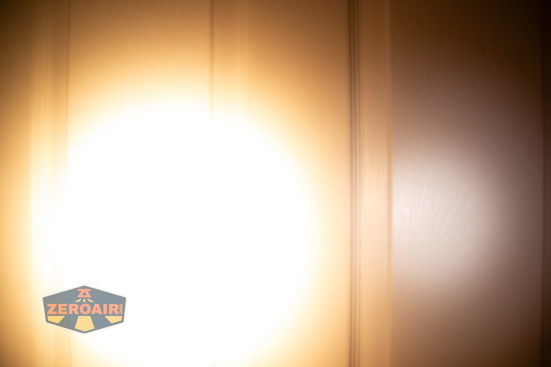 Skilhunt H150V4 3000K headlamp beamshots on door (at 1') compared to nichia 219b 4500K
