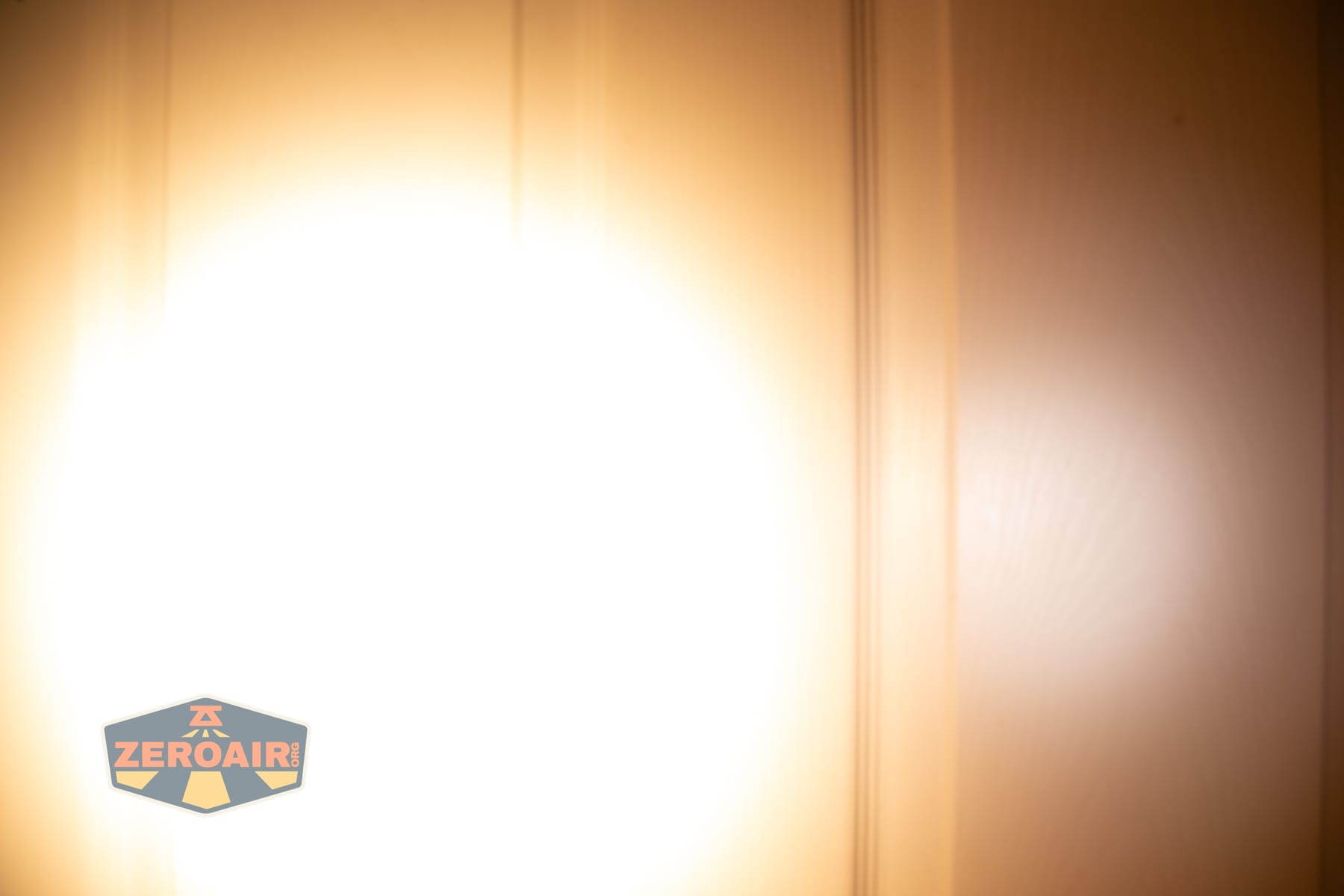 Skilhunt H150V4 3000K headlamp beamshots on door (at 1') compared to nichia 219b 4500K