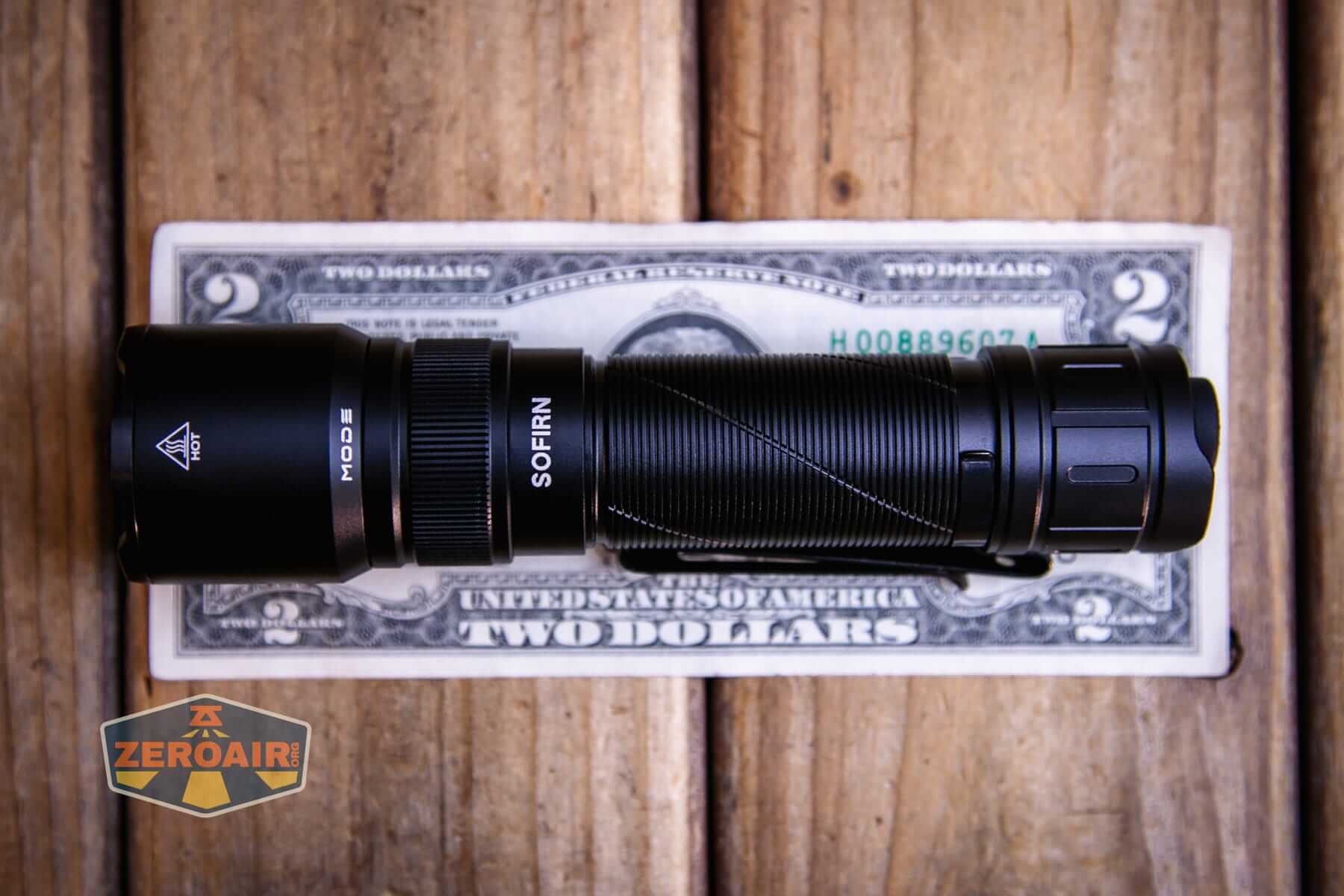 Sofirn SK31 Tactical Duty flashlight on a two dollar bill