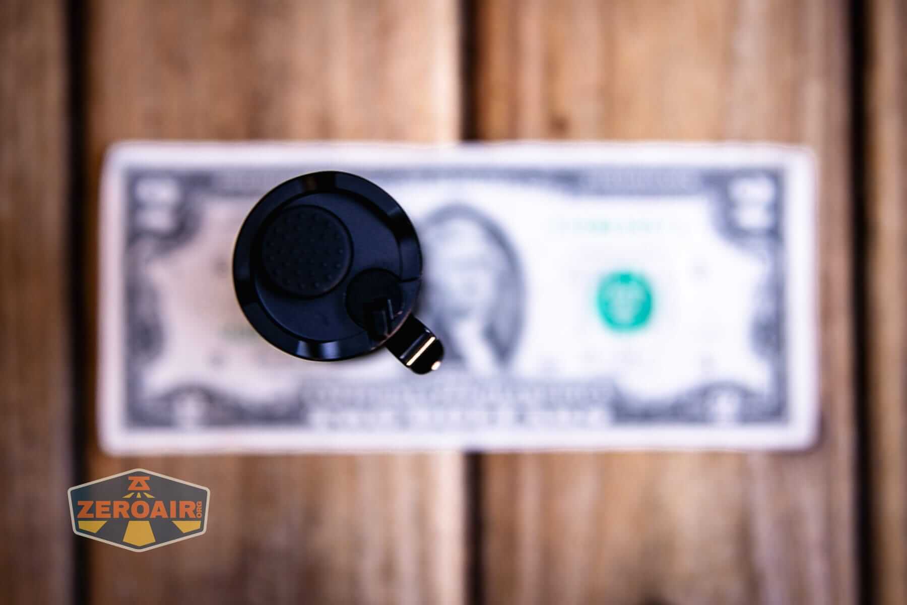 Sofirn SK31 Tactical Duty flashlight on a two dollar bill