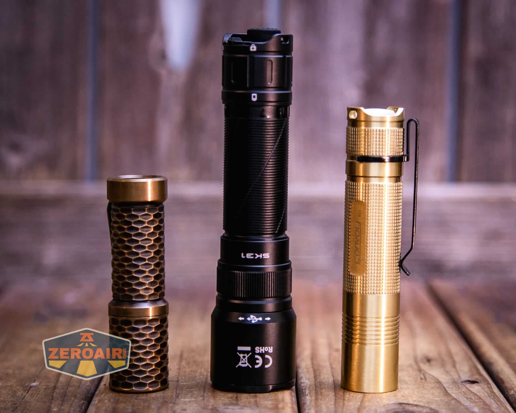 Sofirn SK31 Tactical Duty flashlight with two standard sized flashlights