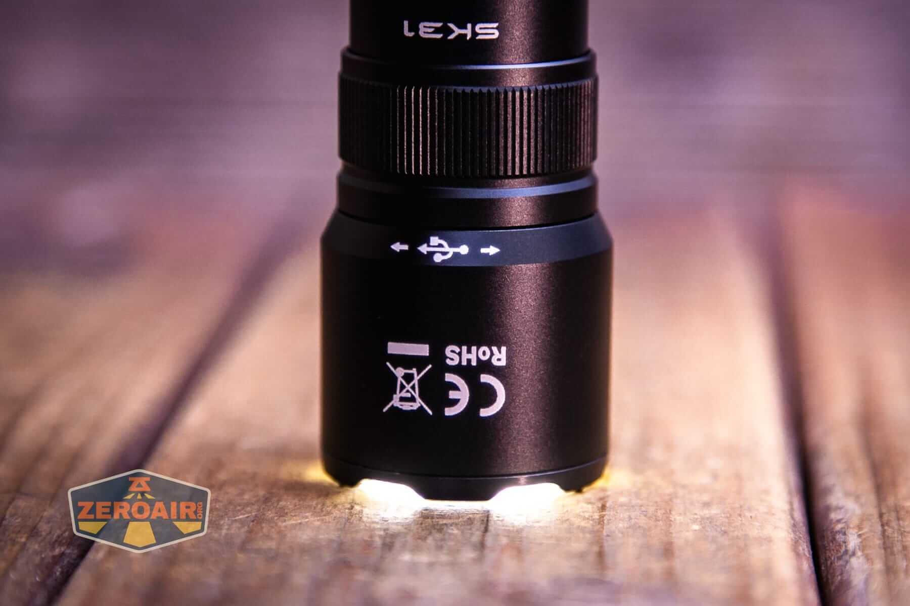 Sofirn SK31 Tactical Duty flashlight emitter on and headstanding