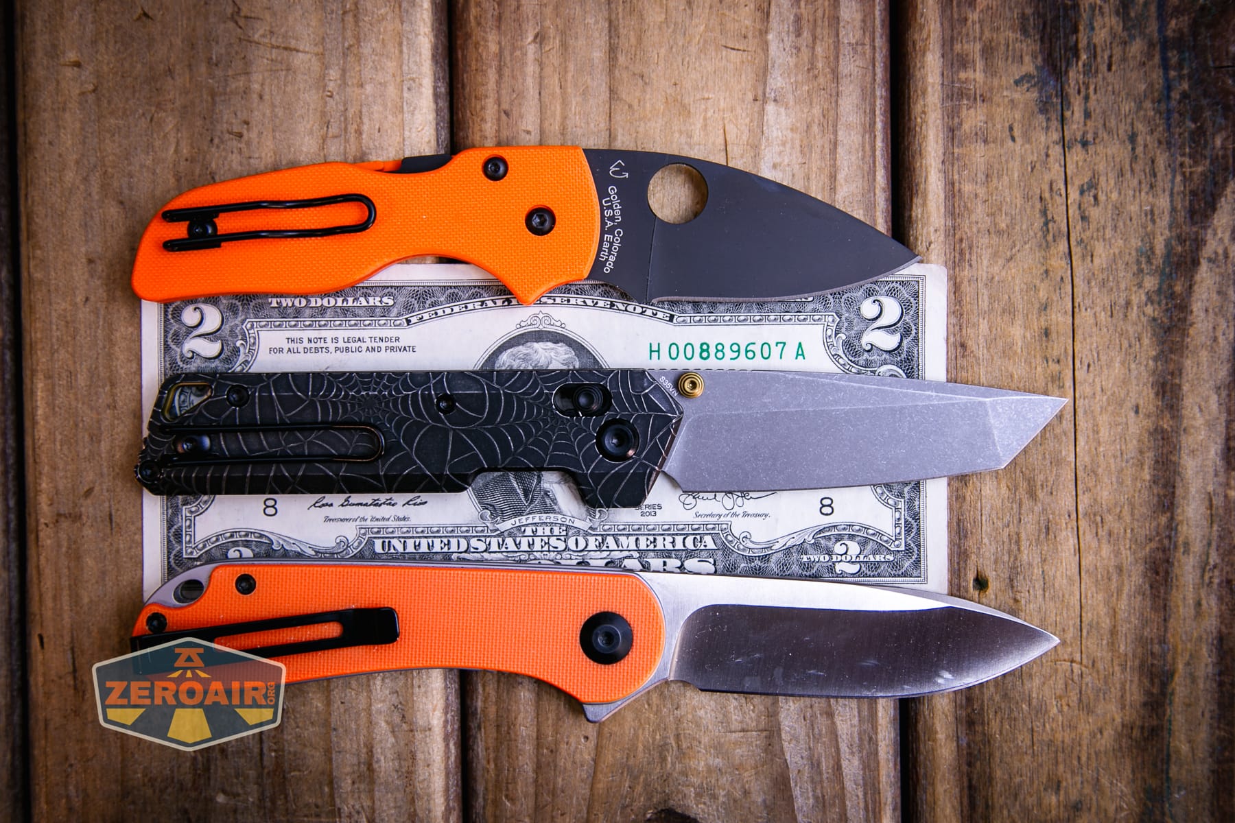 Vosteed Parallel Spiderweb knife on a two dollar bill compared to Civivi Elementum in orange