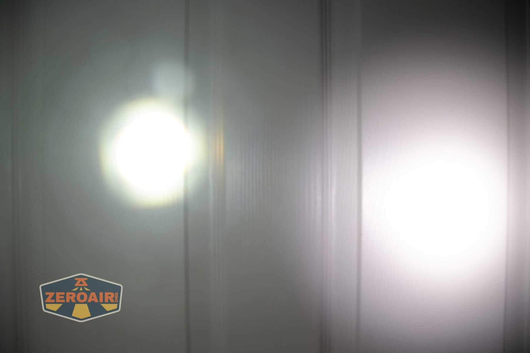 Olight Marauder 3 beamshots on door compared to nichia 219b