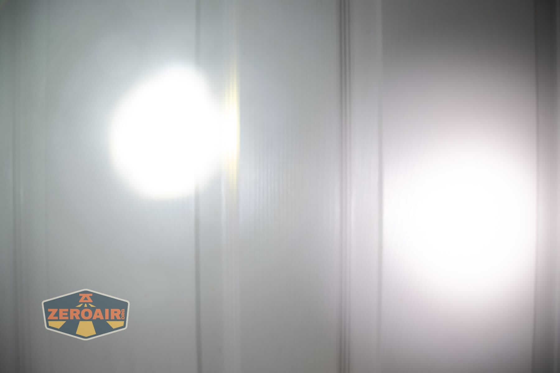 Olight Marauder 3 beamshots on door compared to nichia 219b