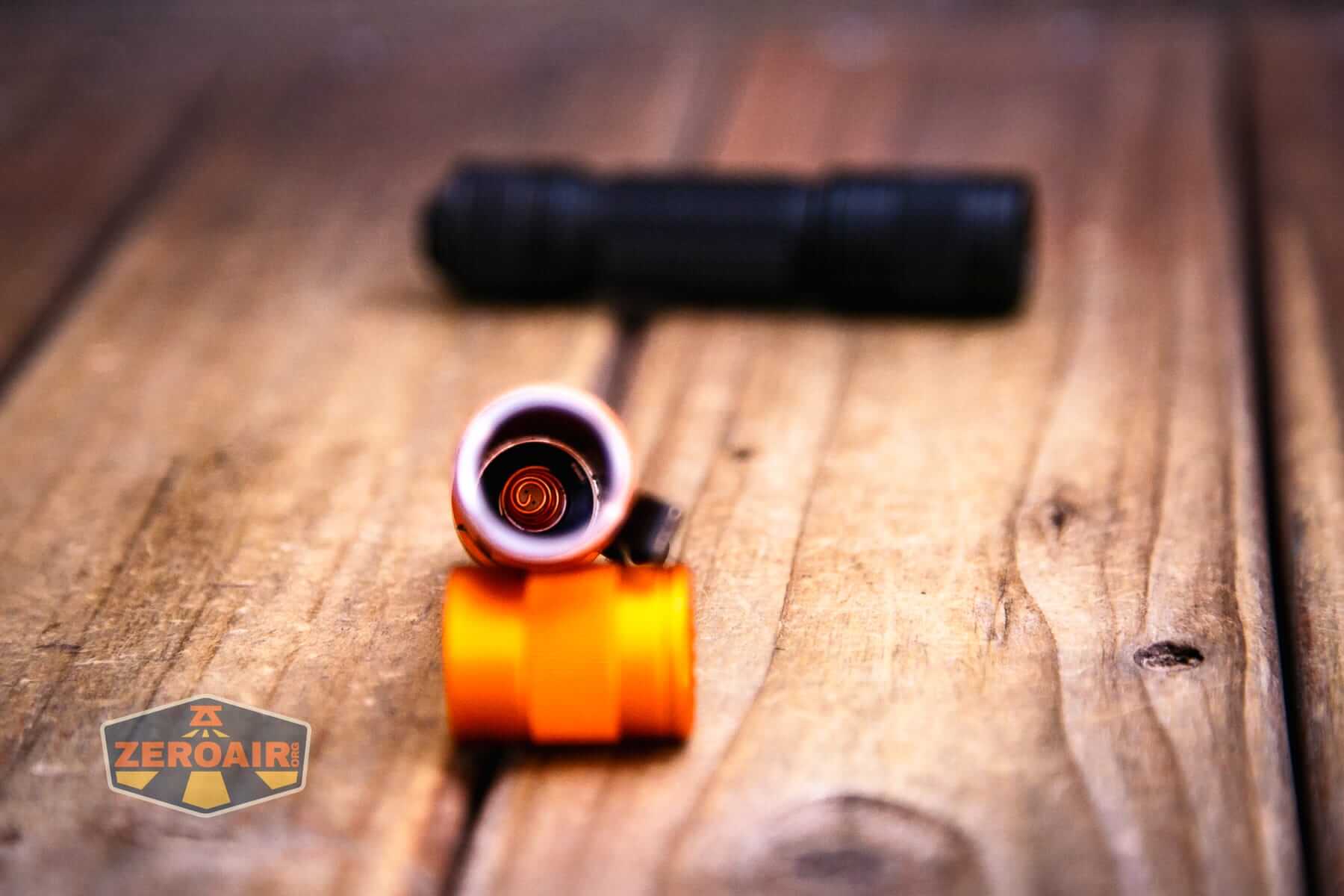 Skilhunt E2A V2 flashlight showing tail spring